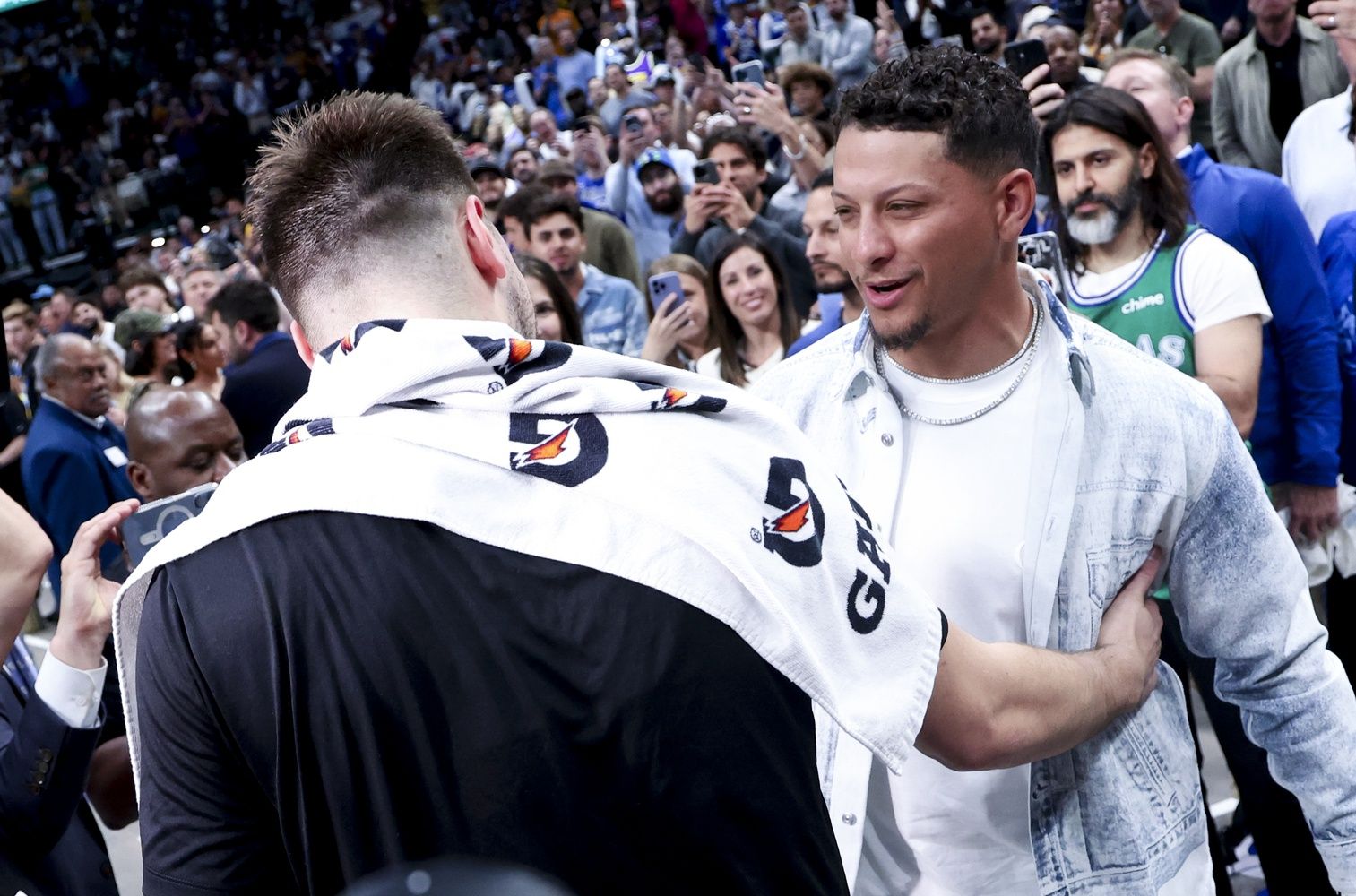 Los Angeles Lakers guard Luka Doncic (77) hugs Kansas City Chiefs quarterback Patrick Mahomes after the game against the Dallas Mavericks at American Airlines Center.