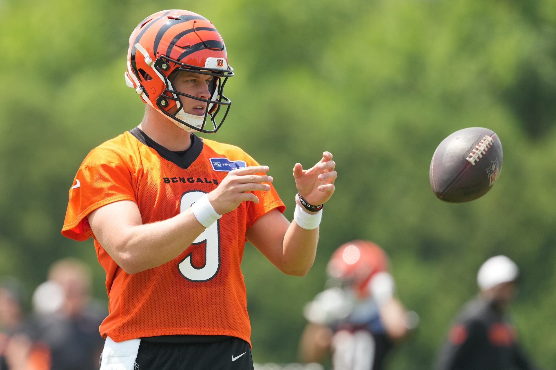 Cincinnati Bengals quarterback Joe Burrow (9) catches a ball during practice at Paycor Stadium.