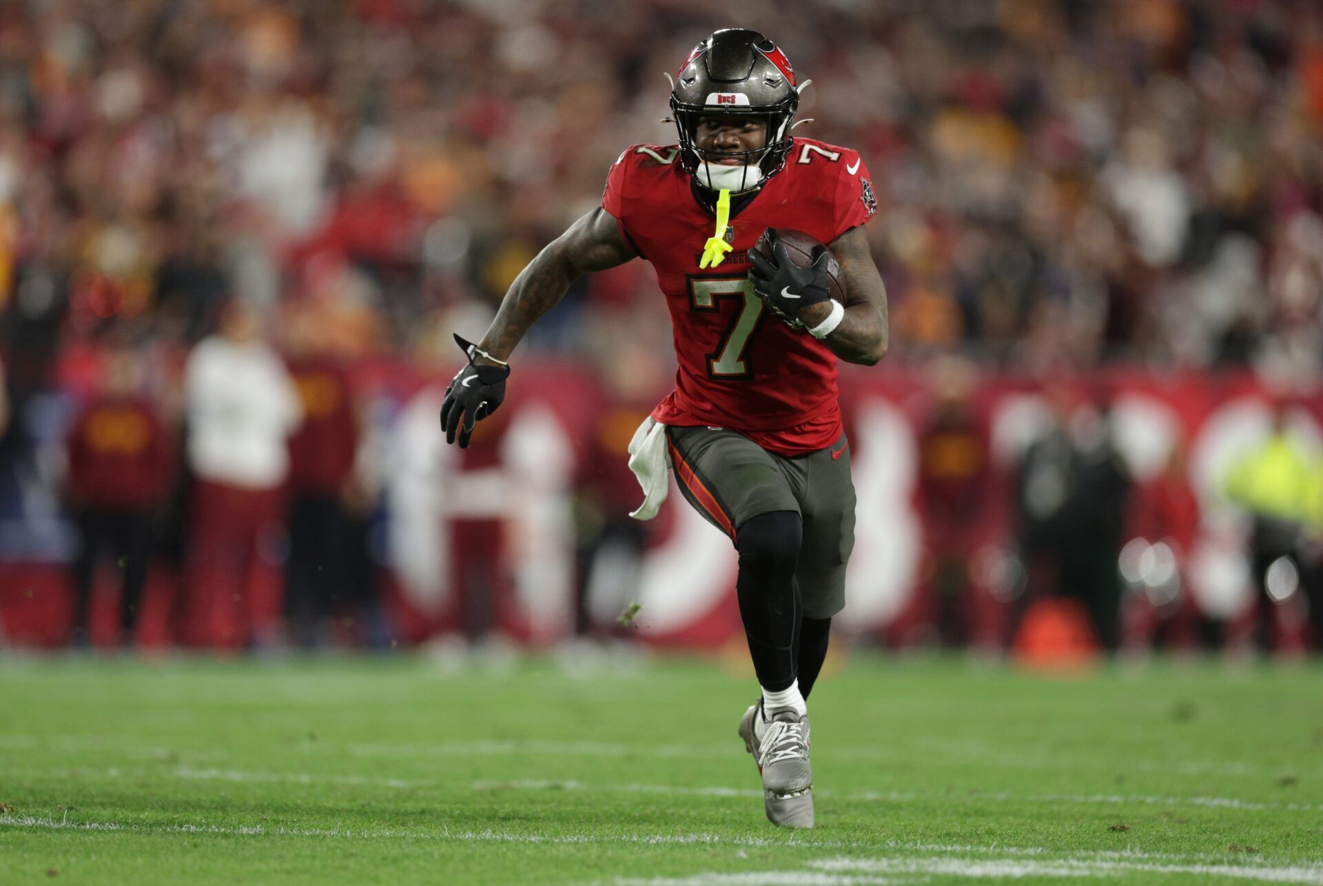 Tampa Bay Buccaneers running back Bucky Irving (7) runs during the fourth quarter of a NFC wild card playoff against the Washington Commanders at Raymond James Stadium.