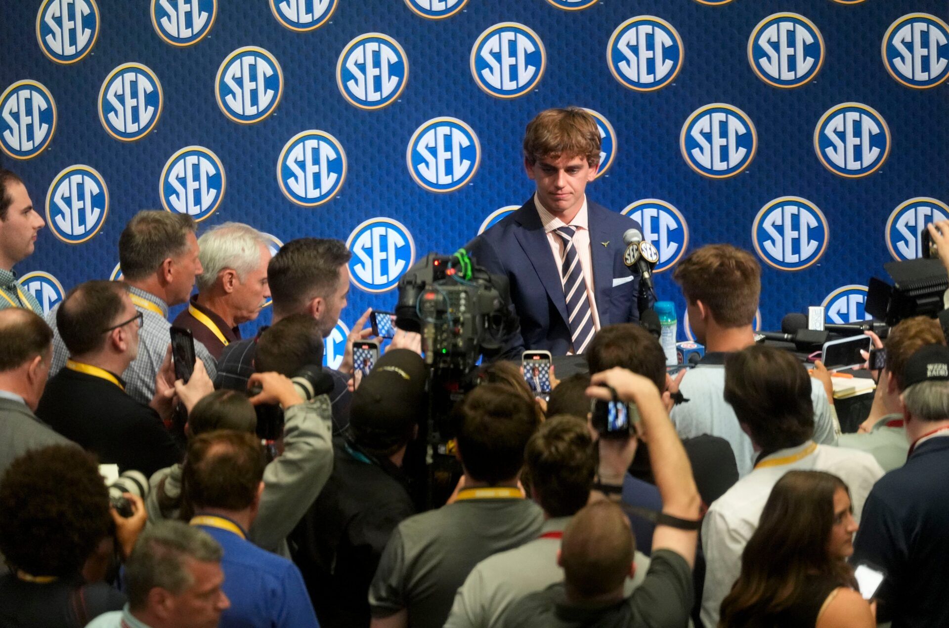 Texas quarterback Arch Manning is surrounded by media as he participates in SEC Media Days at the College Football Hall of Fame in Atlanta.