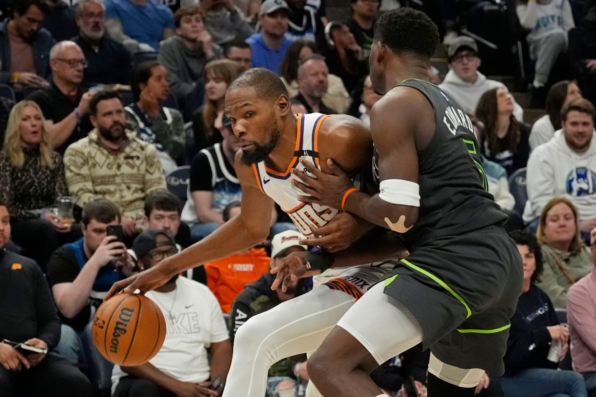 Phoenix Suns forward Kevin Durant (35) works around Minnesota Timberwolves guard Anthony Edwards (5) in the fourth quarter at Target Center.