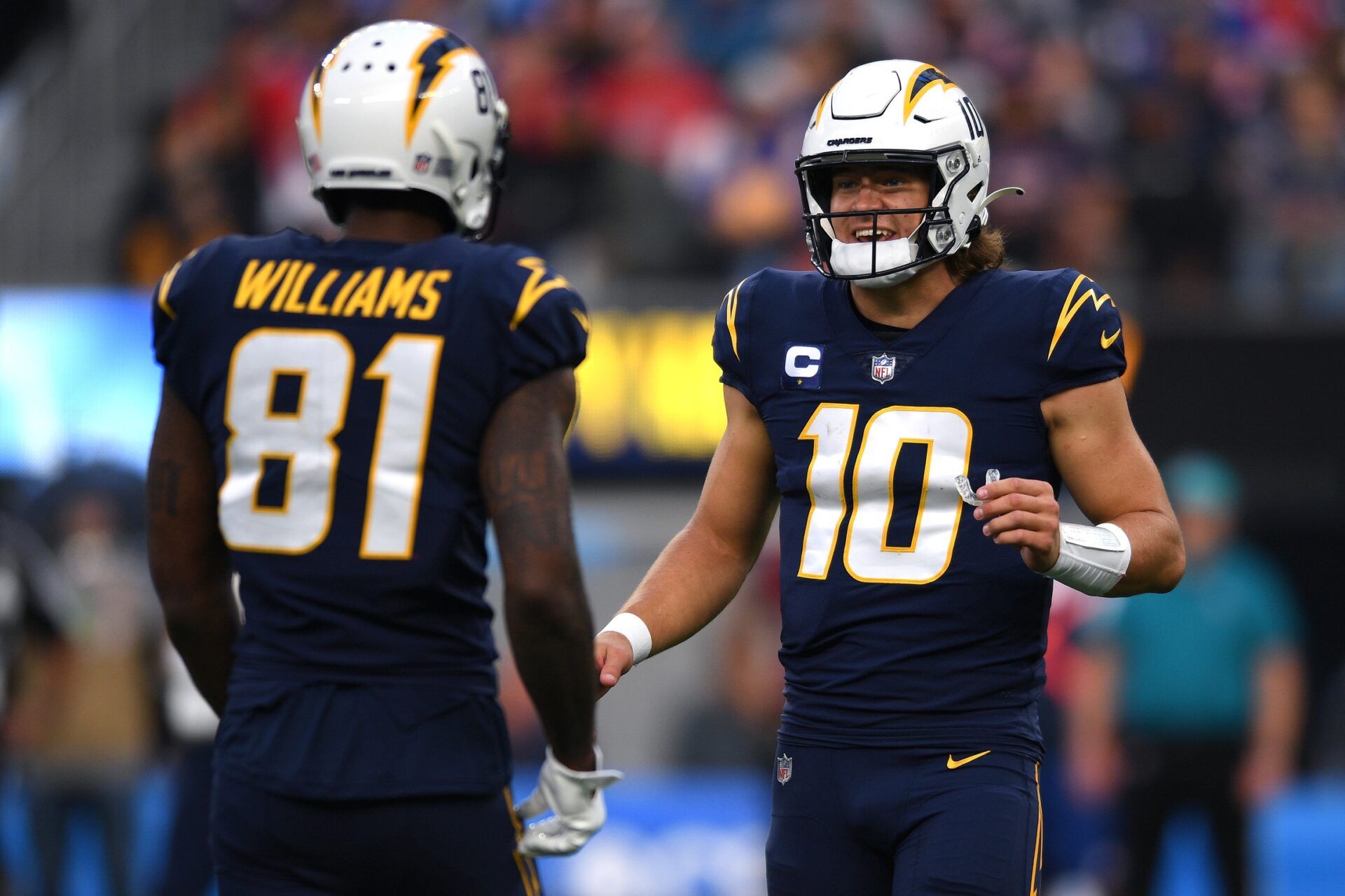 Los Angeles Chargers quarterback Justin Herbert (10) talks to wide receiver Mike Williams (81) during the second half at SoFi Stadium.