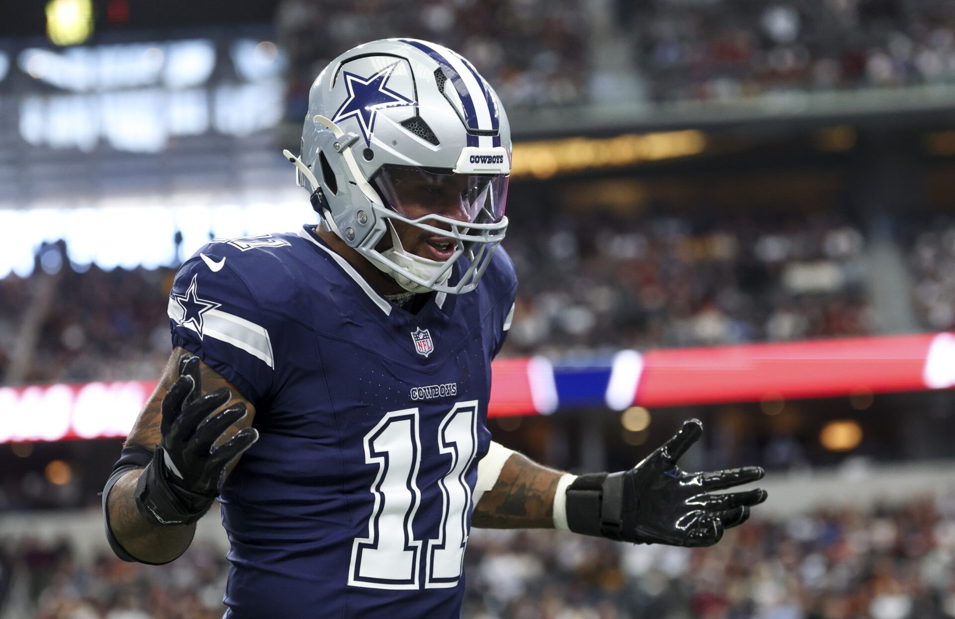 Dallas Cowboys linebacker Micah Parsons (11) celebrates  after a sack during the first quarter against the Washington Commanders at AT&T Stadium.