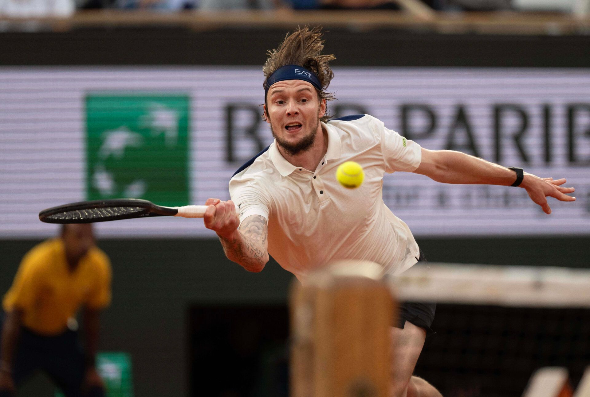 Alexander Bublik of Kazakhstan returns a shot during his match against Jannik Sinner of Italy on day 11 at Roland Garros Stadium.