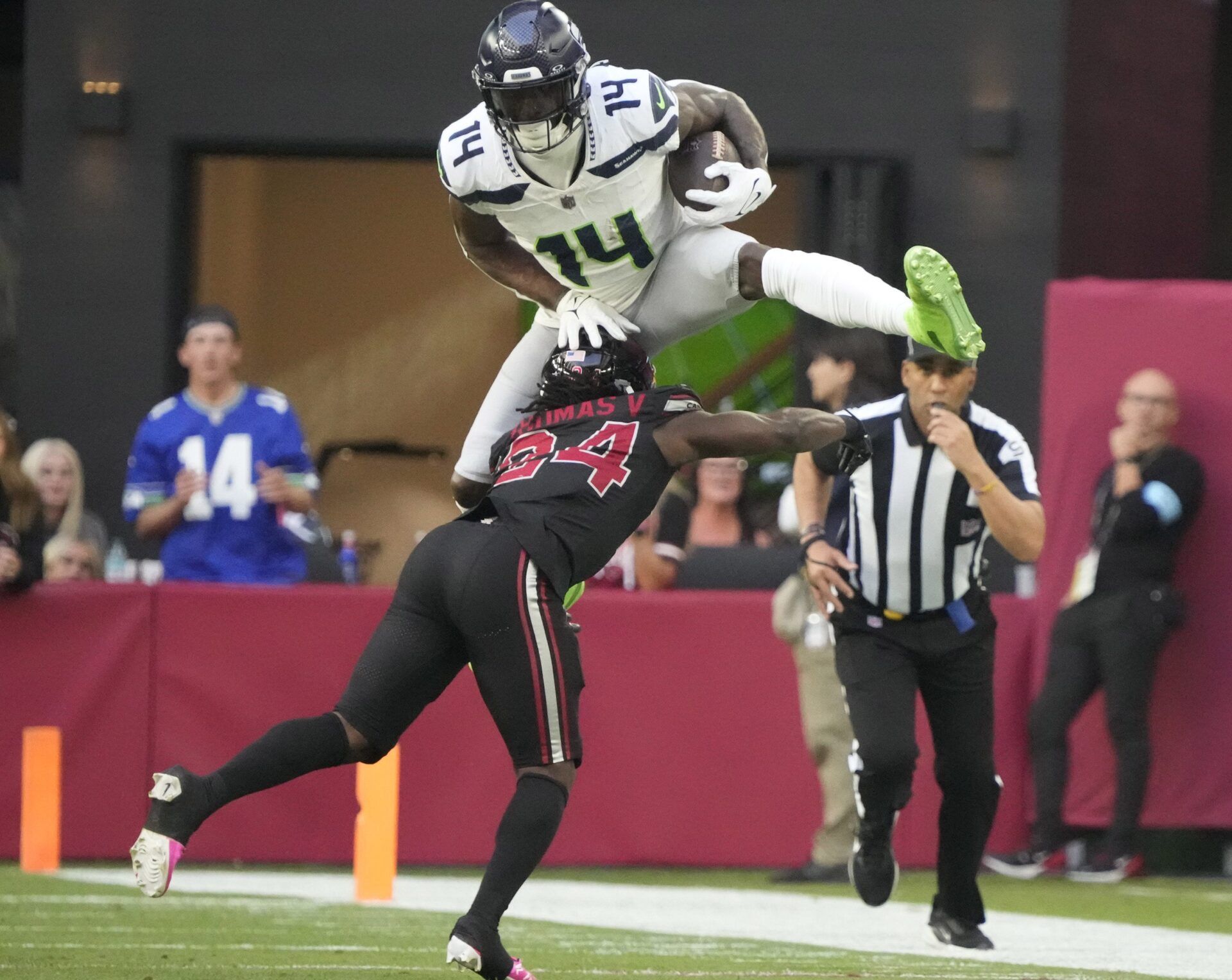 Seattle Seahawks wide receiver DK Metcalf (14) jumps over Arizona Cardinals cornerback Starling Thomas V (24) during the second quarter at State Farm Stadium in Glendale on Dec. 8, 2024.