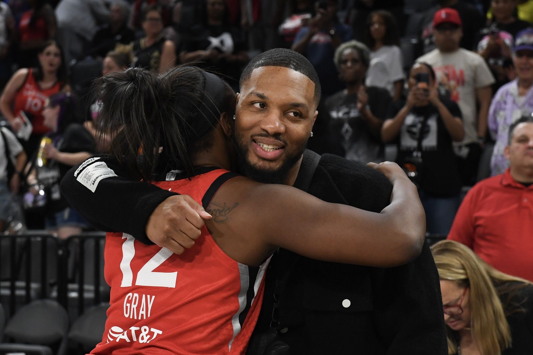 Las Vegas Aces guard Chelsea Gray (12) hugs NBA player Damian Lillard after her game against the Los Angeles Sparks at Michelob Ultra Arena.