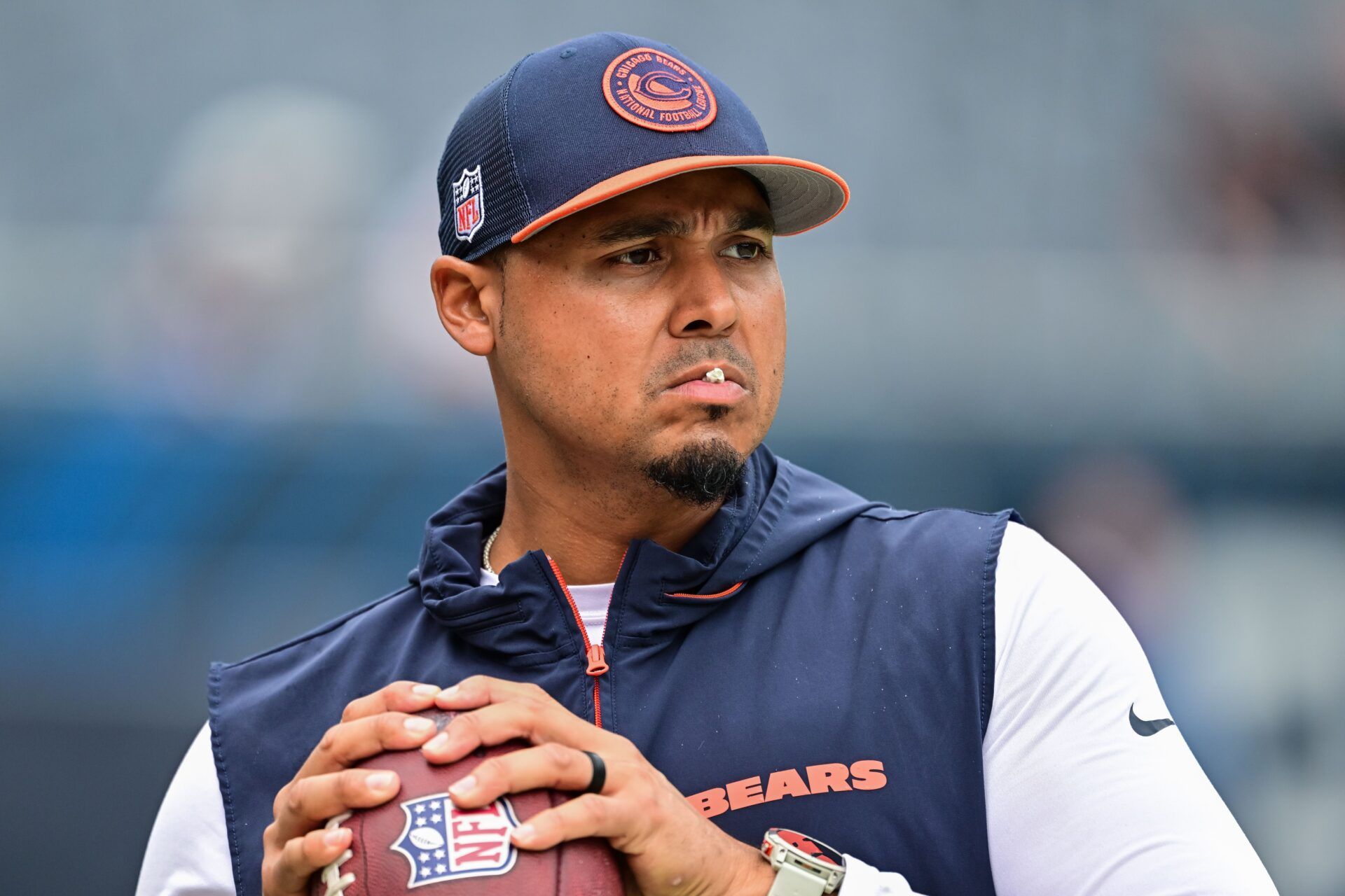 Chicago Bears general manager Ryan Poles plays catch on the sideline before the game against the Cincinnati Bengals at Soldier Field.