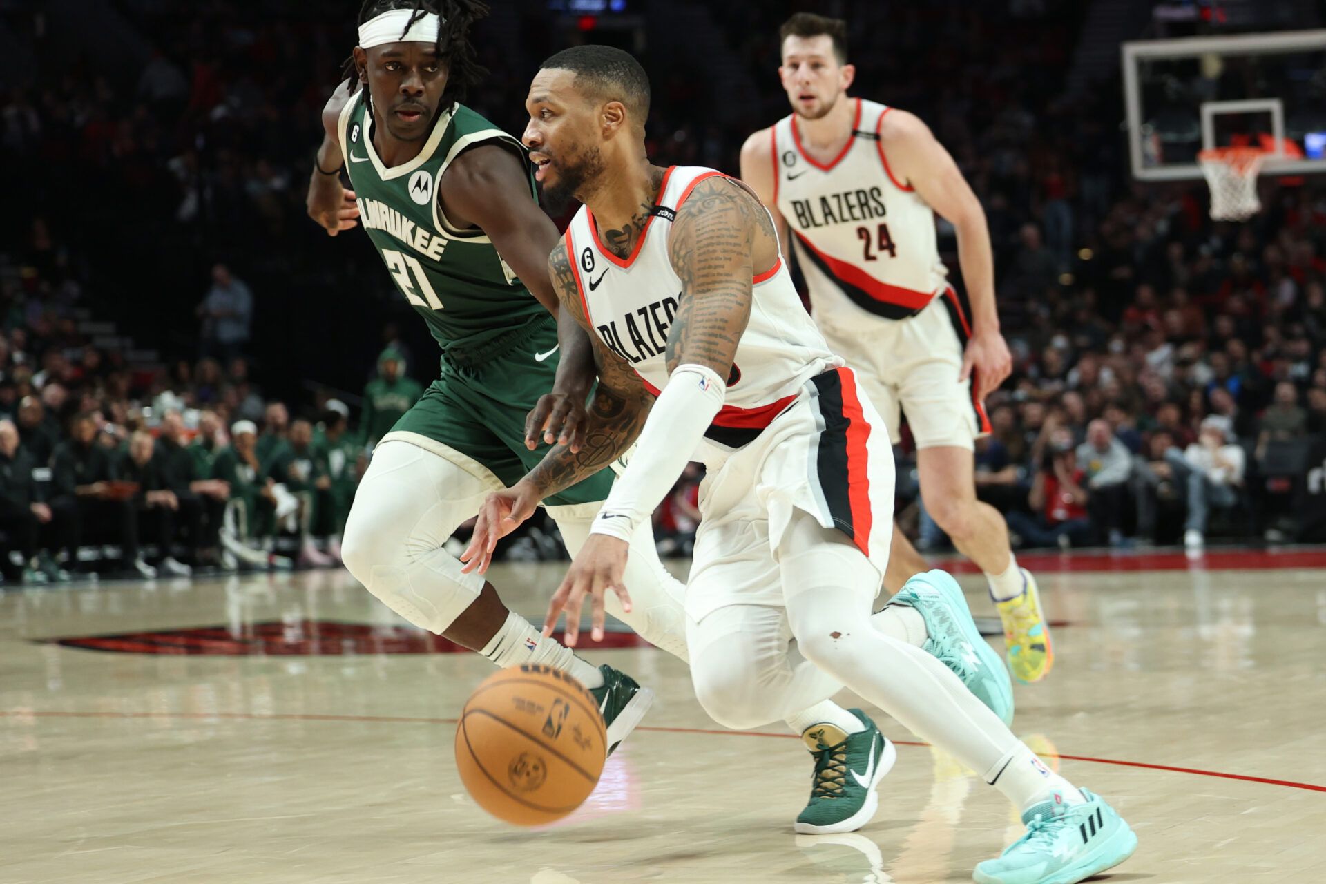 Portland Trail Blazers guard Damian Lillard (0) drives the lane against Milwaukee Bucks guard Jrue Holiday (21) in the second half at Moda Center.