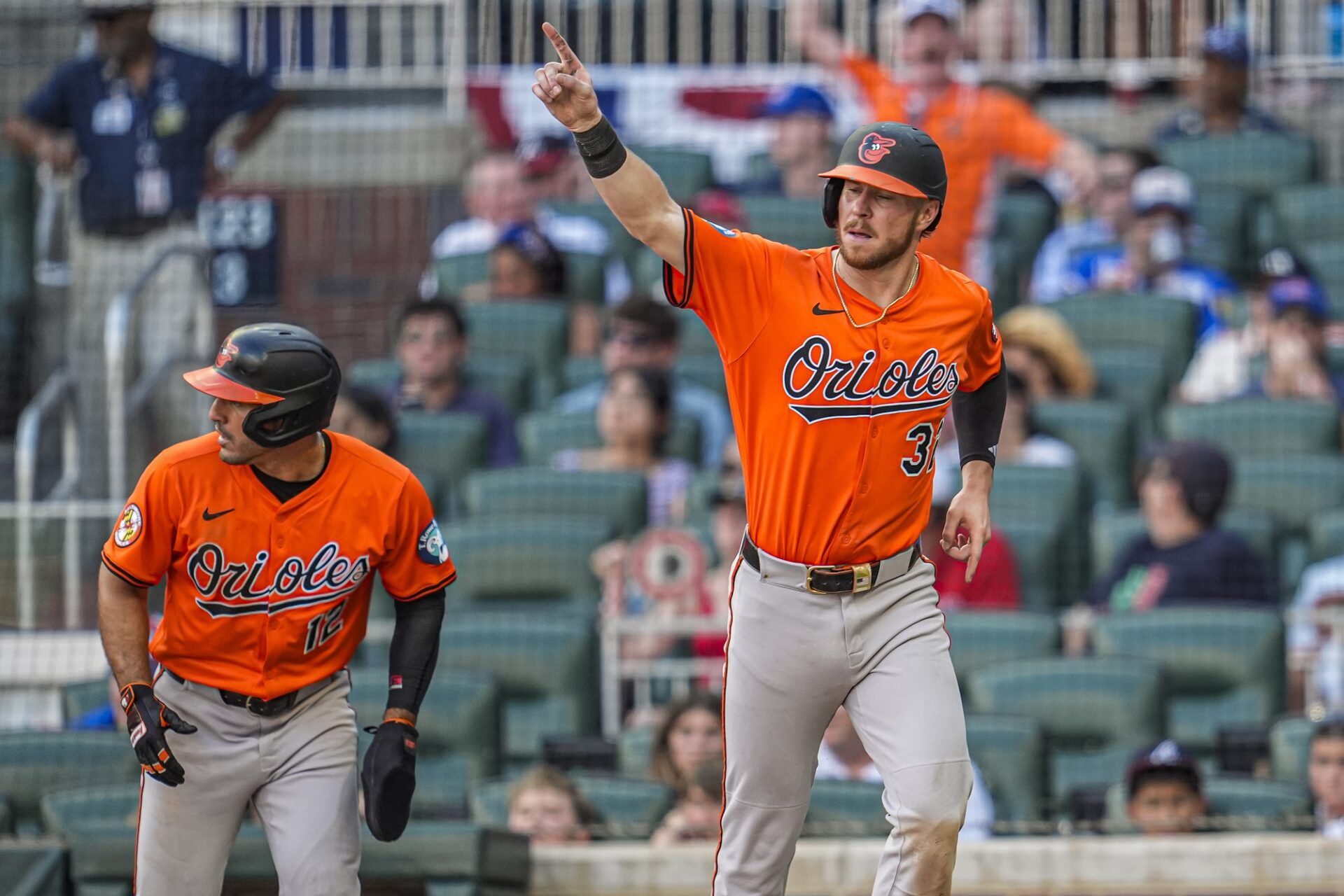 Baltimore Orioles first baseman Ryan O'Hearn (32) and right fielder Ramon Laureano (rear left) react after scoring against the Atlanta Braves during the tenth inning at Truist Park.