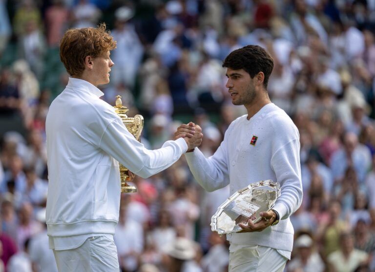 Carlos Alcaraz of Spain and Jannik Sinner of Italy pose with their trophies after the menÕs singles final on day 14 at All England Lawn Tennis and Croquet Club.