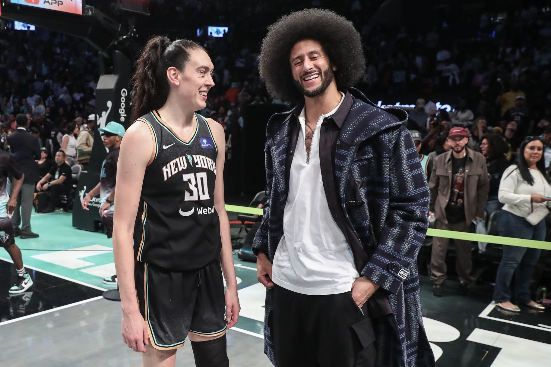 New York Liberty forward Breanna Stewart (30) talks with former NFL quarterback Colin Kaepernick after defeating Las Vegas Aces 88-84 in game two of the 2024 WNBA Semi-finals at Barclays Center.