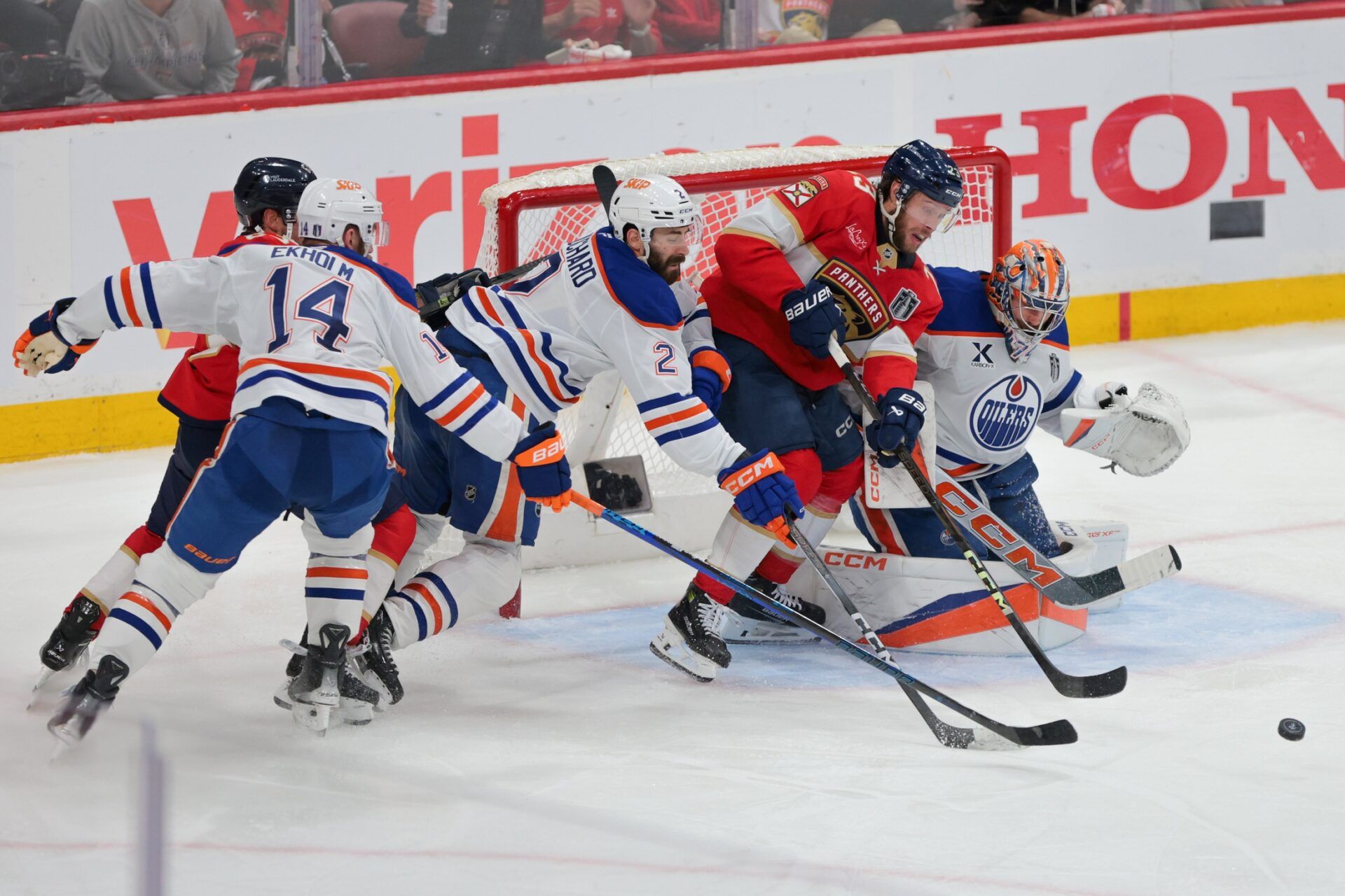 Florida Panthers center Carter Verhaeghe (23) goes after the puck defended by Edmonton Oilers defenseman Evan Bouchard (2) and goaltender Stuart Skinner (74) during the third period in game six of the 2025 Stanley Cup Final at Amerant Bank Arena.