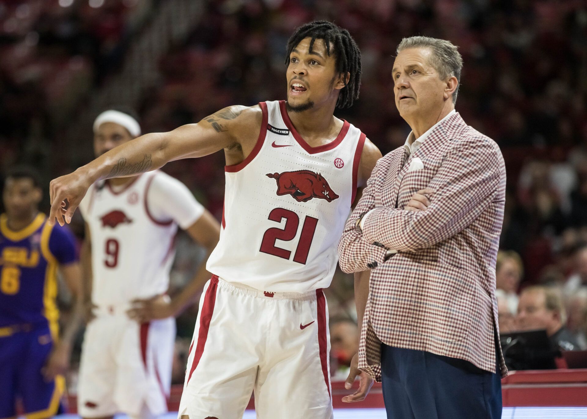 Arkansas Razorbacks guard D.J. Wagner (21) talks with head coach John Calipari during a break in the action against the LSU Tigers at Bud Walton Arena. Arkansas won 70-58.