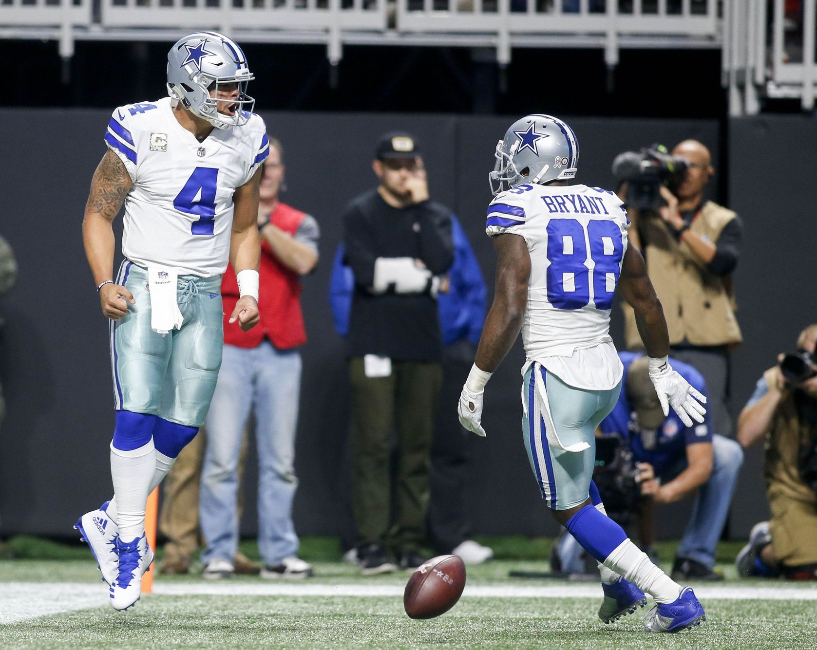 Dallas Cowboys quarterback Dak Prescott (4) celebrates a touchdown with wide receiver Dez Bryant (88) against the Atlanta Falcons in the first quarter at Mercedes-Benz Stadium.