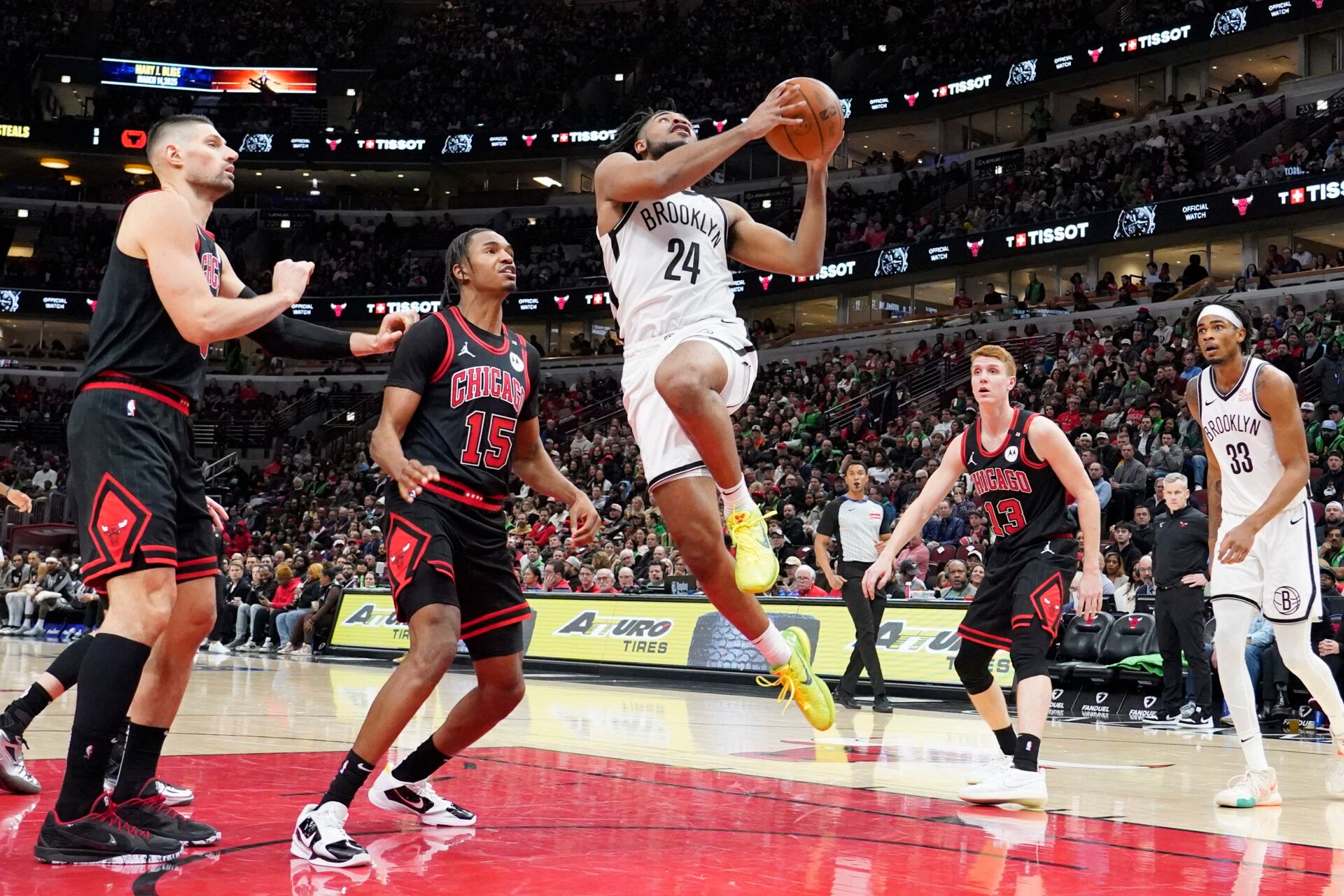 Chicago Bulls forward Julian Phillips (15) defends Brooklyn Nets guard Cam Thomas (24) during the second half at United Center.