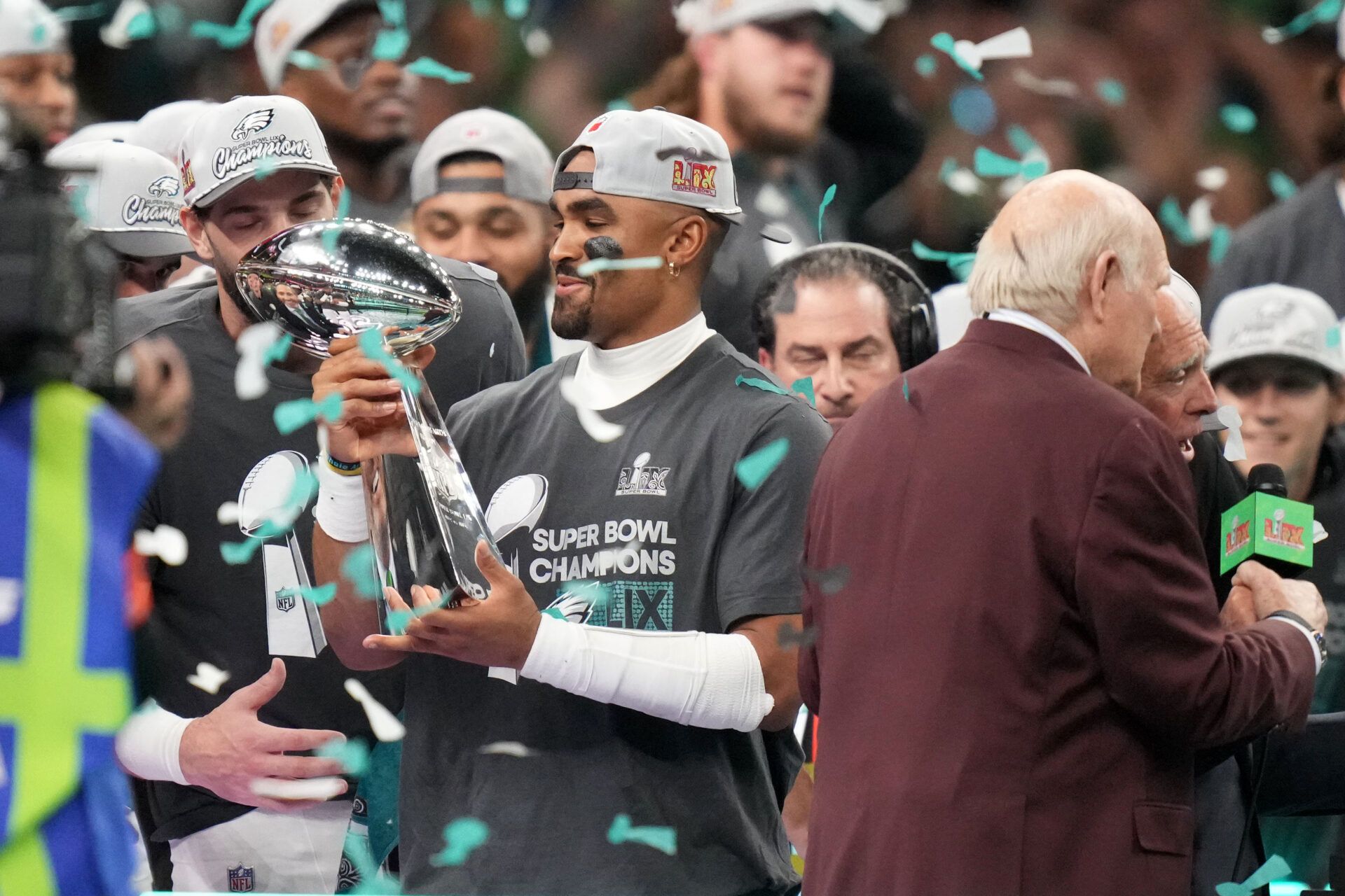 Philadelphia Eagles quarterback Jalen Hurts (1) hoists the Vince Lombardi Trophy after defeating the Kansas City Chiefs in Super Bowl LIX at Ceasars Superdome.