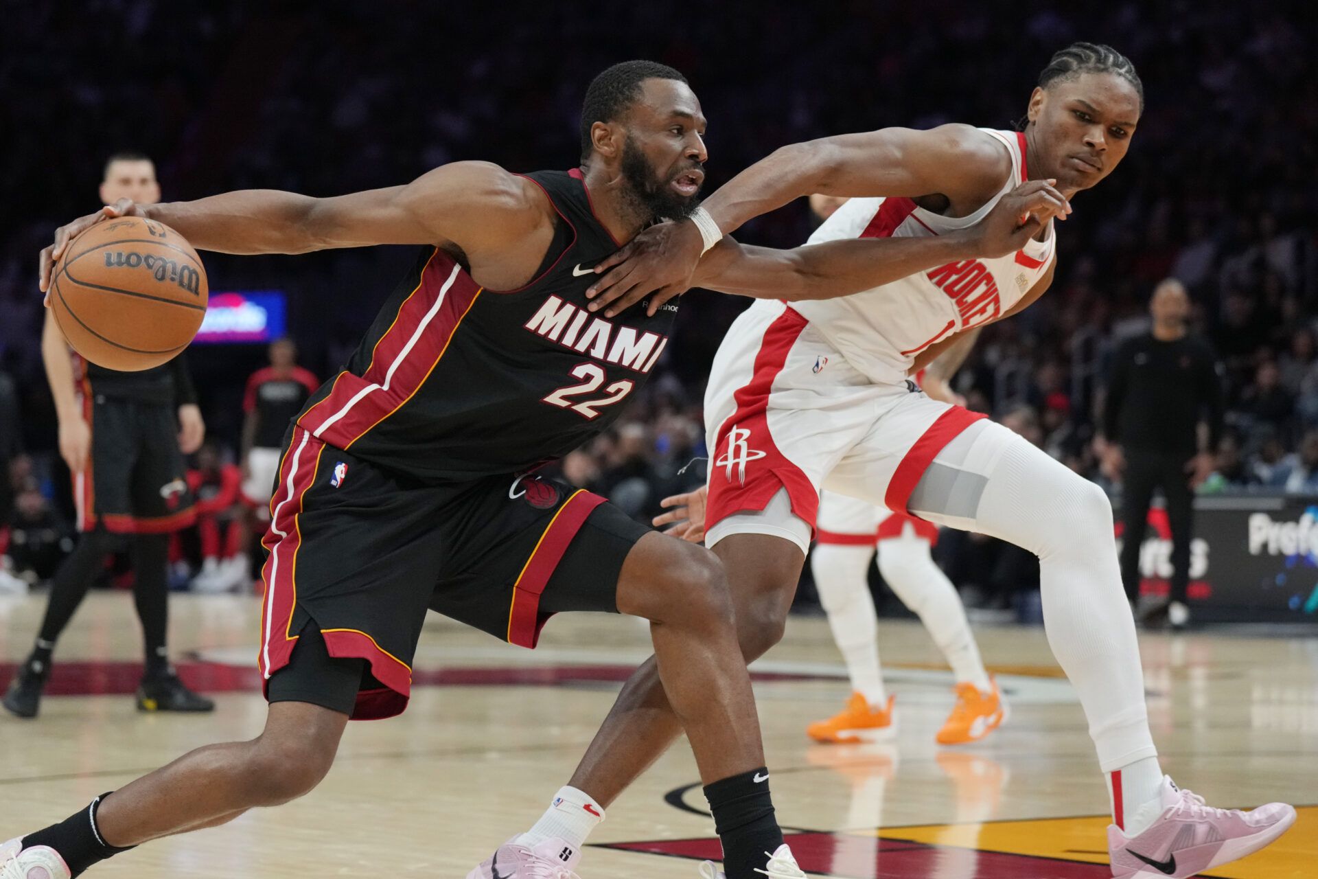 Miami Heat forward Andrew Wiggins (22) gets tangled up with Houston Rockets forward Amen Thompson (1) in the second half at Kaseya Center.