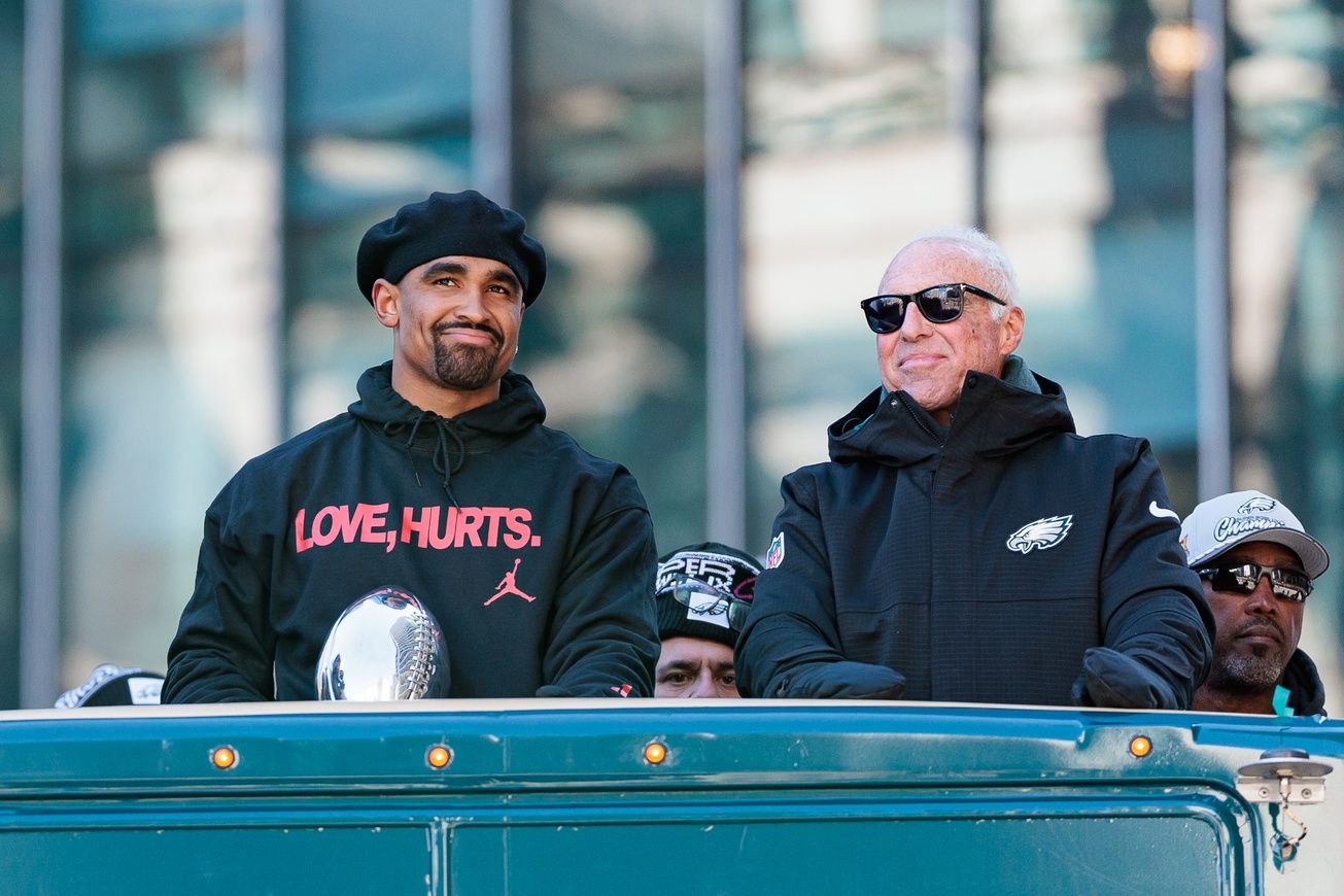 Philadelphia Eagles quarterback Jalen Hurts (1) speaks to team owner Jeffrey Lurie during the Super Bowl LIX championship parade and rally.