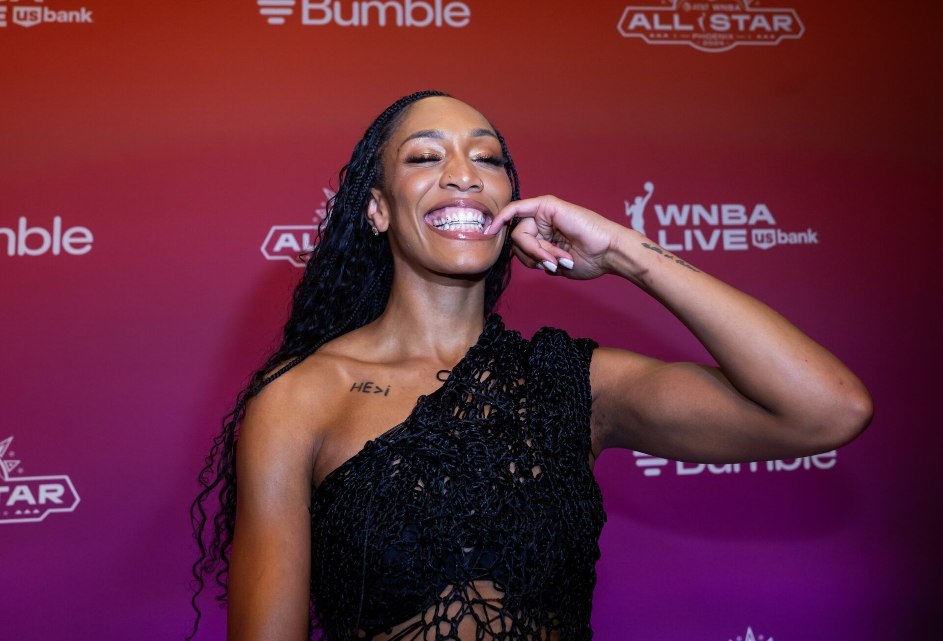 Las Vegas Aces player A'ja Wilson shows her grill teeth as she walks the red carpet during the WNBA All Star weekend at the Phoenix Convention Center.