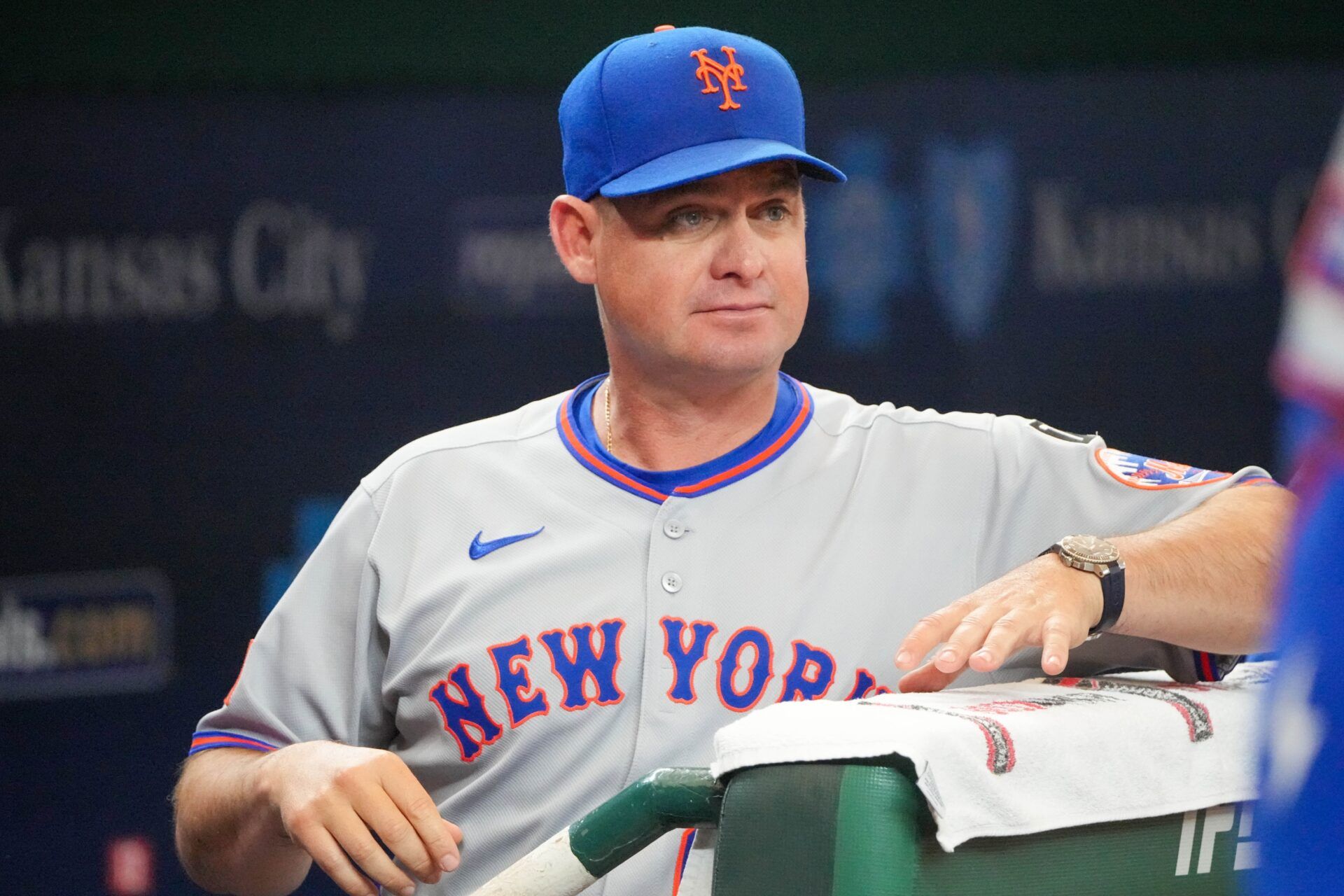 New York Mets manager Carlos Mendoza (64) watches from the dugout against the Kansas City Royals prior to a game at Kauffman Stadium.