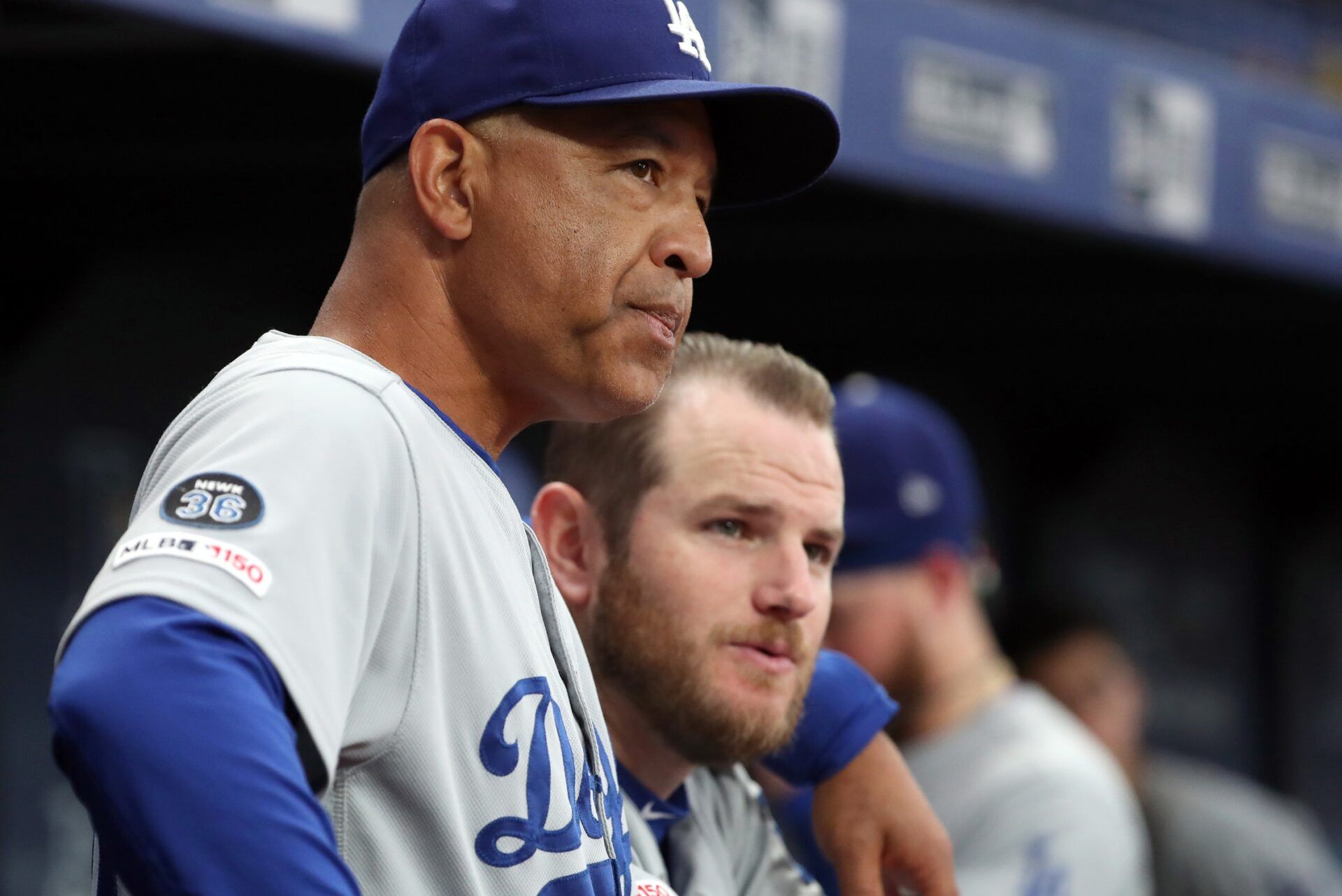 Los Angeles Dodgers manager Dave Roberts (30) talks with first baseman Max Muncy (13) in the dugout during the first inning against the Tampa Bay Rays at Tropicana Field.