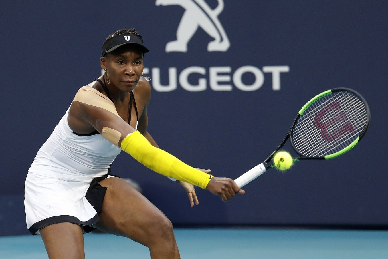 Venus Williams of the United States hits a backhand against Simona Halep of Romania (not pictured) in the fourth round of the Miami Open at Miami Open Tennis Complex.