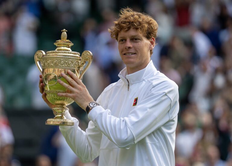 Jannik Sinner of Italy poses with the trophy after winning the menÕs singles final match against Carlos Alcaraz of Spain on day 14 at All England Lawn Tennis and Croquet Club.