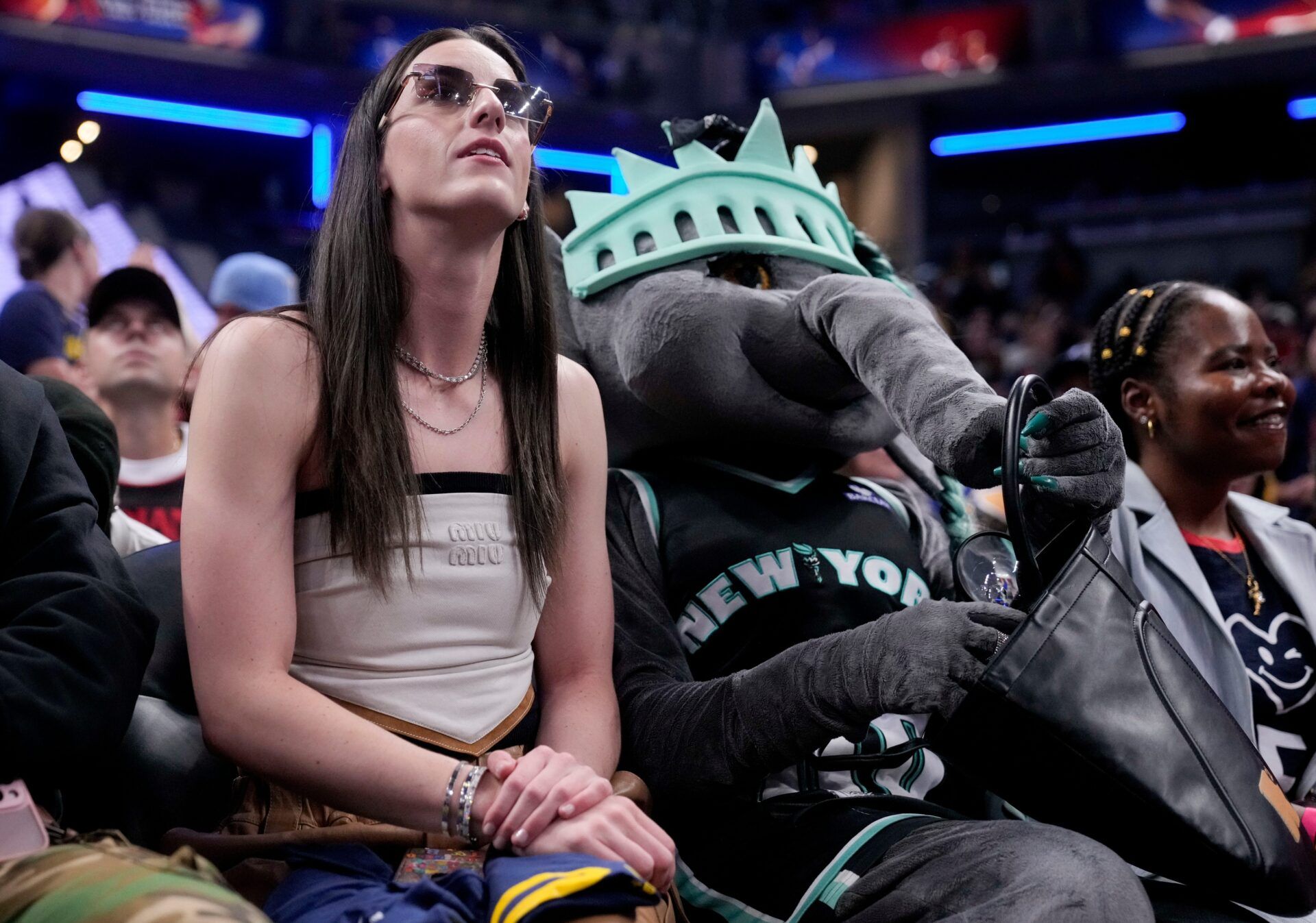 Indiana Fever's Caitlin Clark (22) sits with New York Liberty mascot Ellie the Elephant on Friday, July 18, 2025, ahead of the WNBA All-Star 3-point and skills contests at Gainbridge Fieldhouse in Indianapolis.