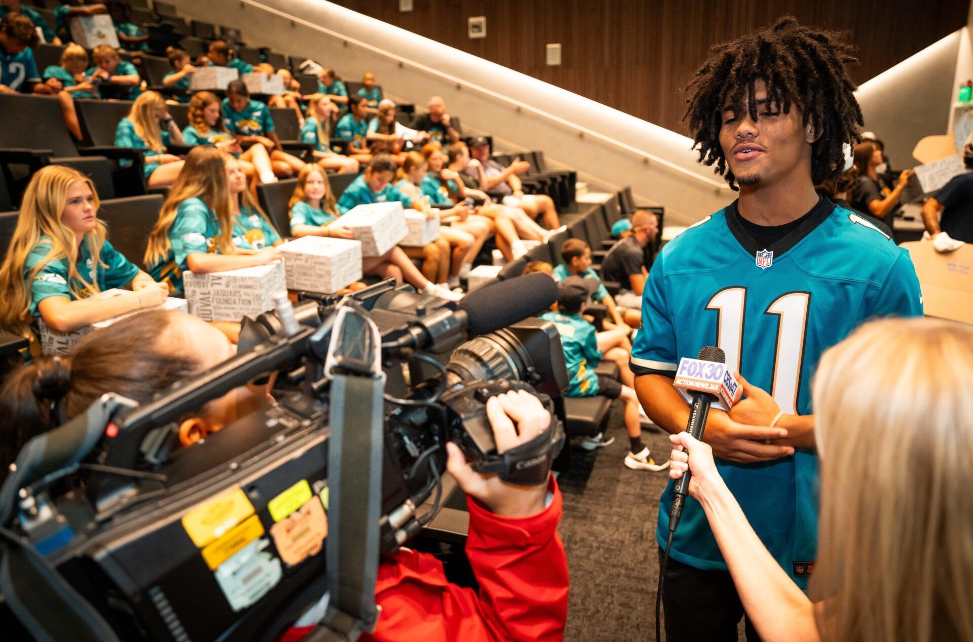 Brysen Wright, 14, is interviewed by the media because he played in the flag football playoffs last year and is also playing this year for the 14U team. The Jacksonville Jaguars sponsored a sendoff party Sunday July 13, 2025 at Miller Electric Center in Jacksonville, Fla. for their flag football teams that they sponsor for the NFL Flag Championships next week in Canton, Ohio. [Doug Engle/Florida Times-Union]