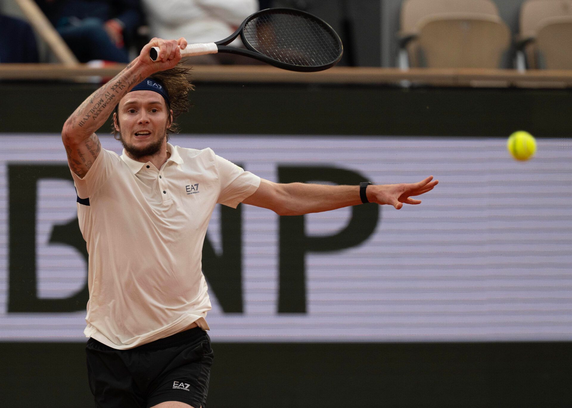 Alexander Bublik of Kazakhstan returns a shot during his match against Jannik Sinner of Italy on day 11 at Roland Garros Stadium.