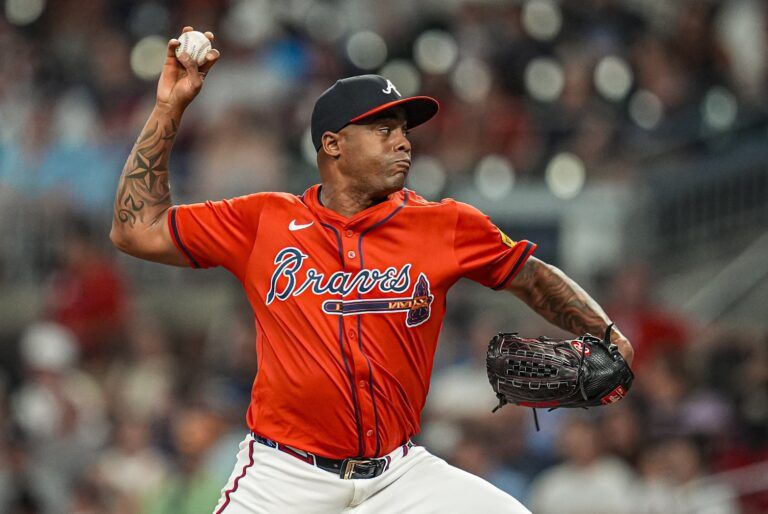 Atlanta Braves relief pitcher Raisel Iglesias (26) pitches against the New York Yankees during the ninth inning at Truist Park.