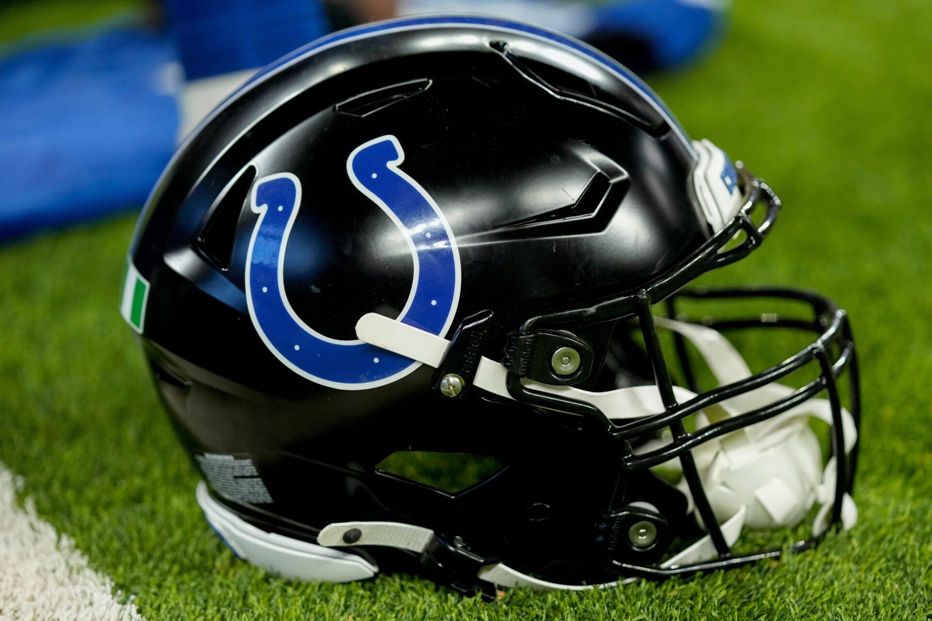 A black Indianapolis Colts helmet sits on the turf Sunday, Nov. 24, 2024, during a game against the Detroit Lions at Lucas Oil Stadium in Indianapolis.
