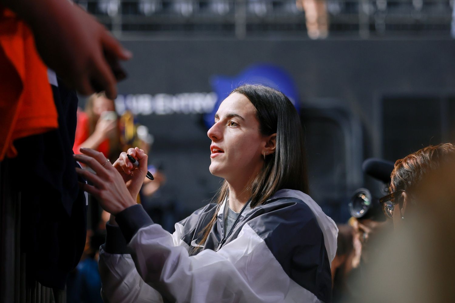 Indiana Fever guard Caitlin Clark (22) signs autographs for fans before the game against the Washington Mystics at Entertainment & Sports Arena.