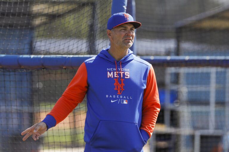 New York Mets hitting coach Eric Chavez looks on as players take batting practice during spring training.