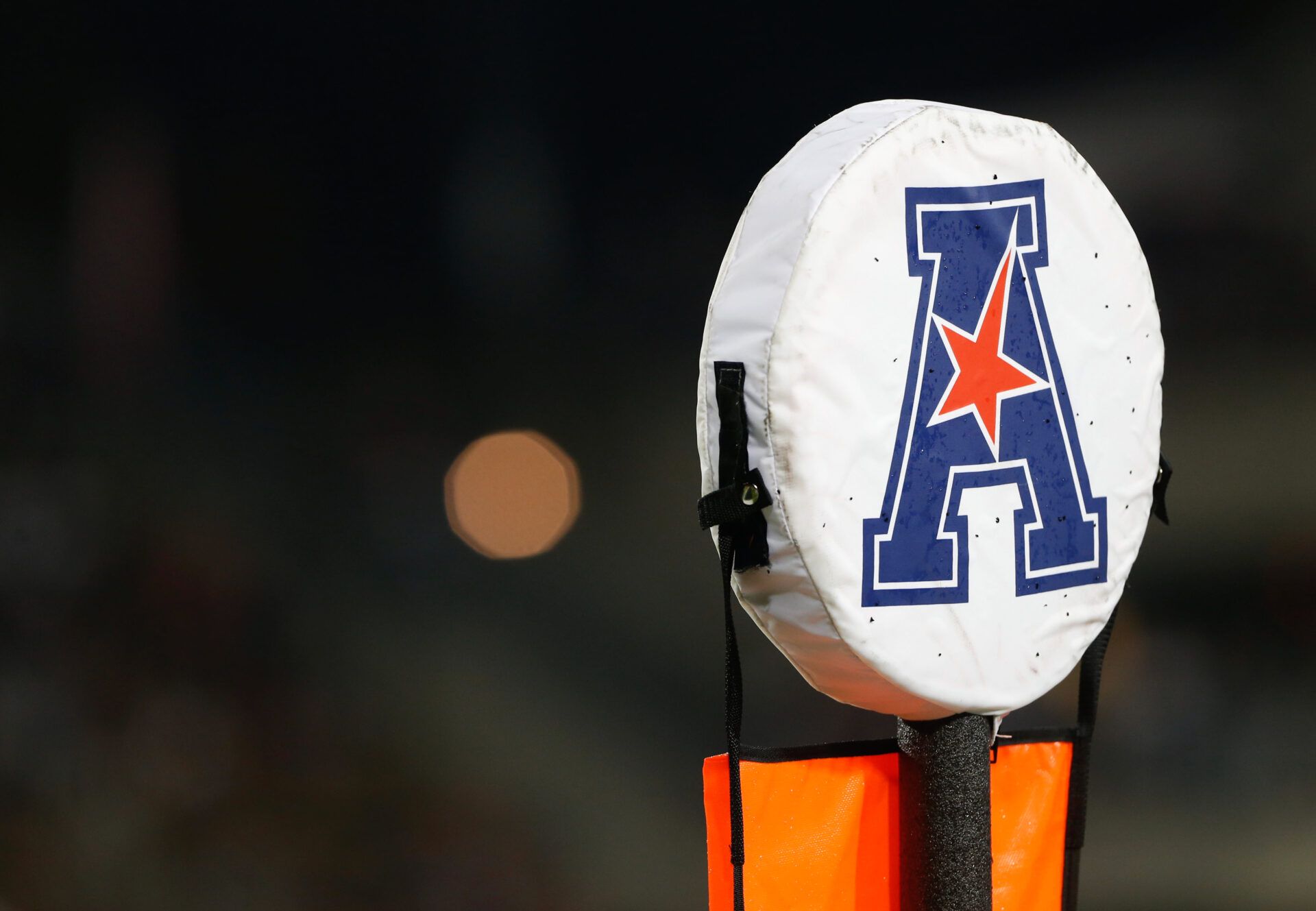 A detailed view of the American Athletic Conference logo on a field marker at Nippert Stadium. The Bearcats won 52-10.