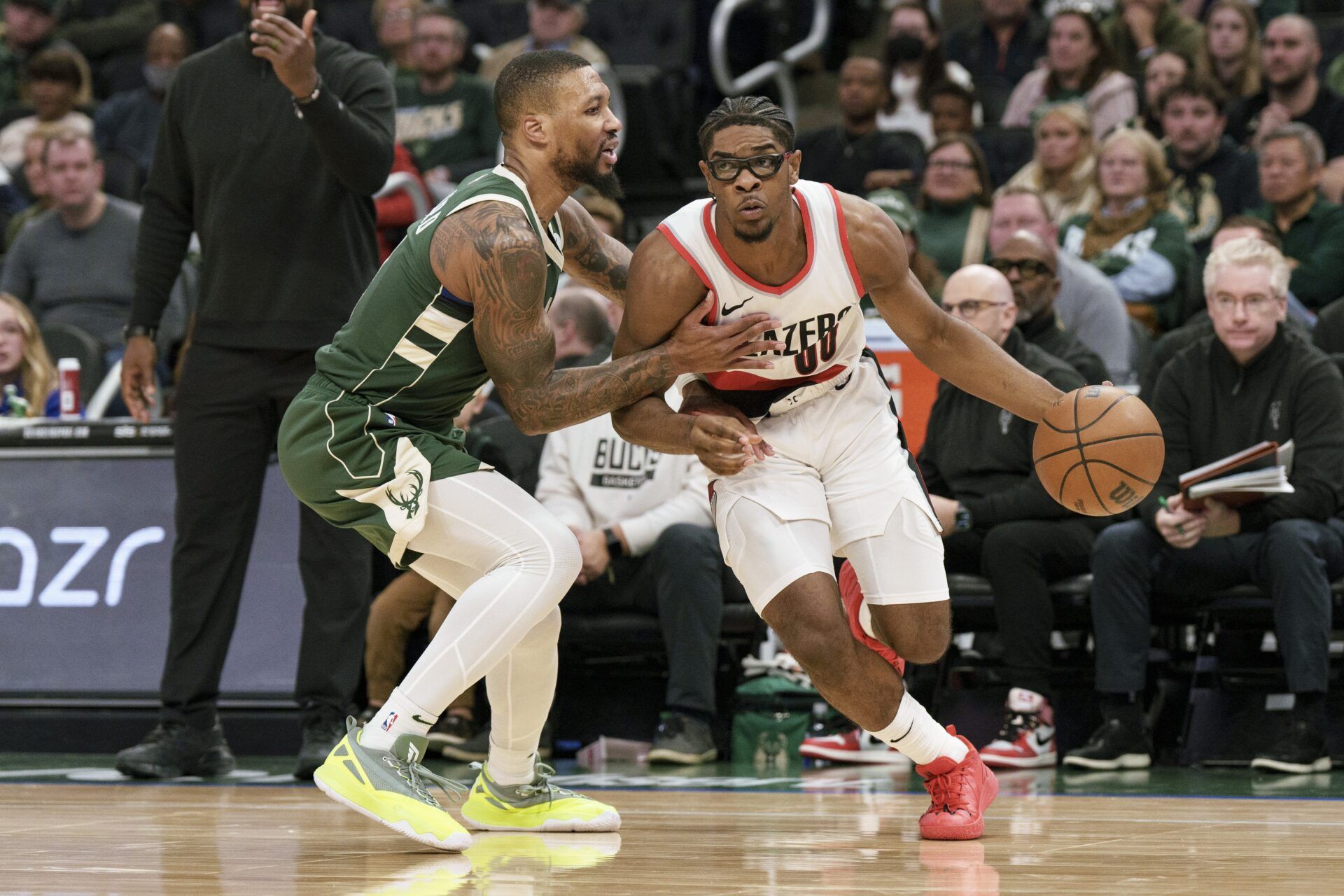 Portland Trail Blazers guard Scoot Henderson (00) drives for the basket against Milwaukee Bucks guard Damian Lillard (0) during the third quarter at Fiserv Forum.