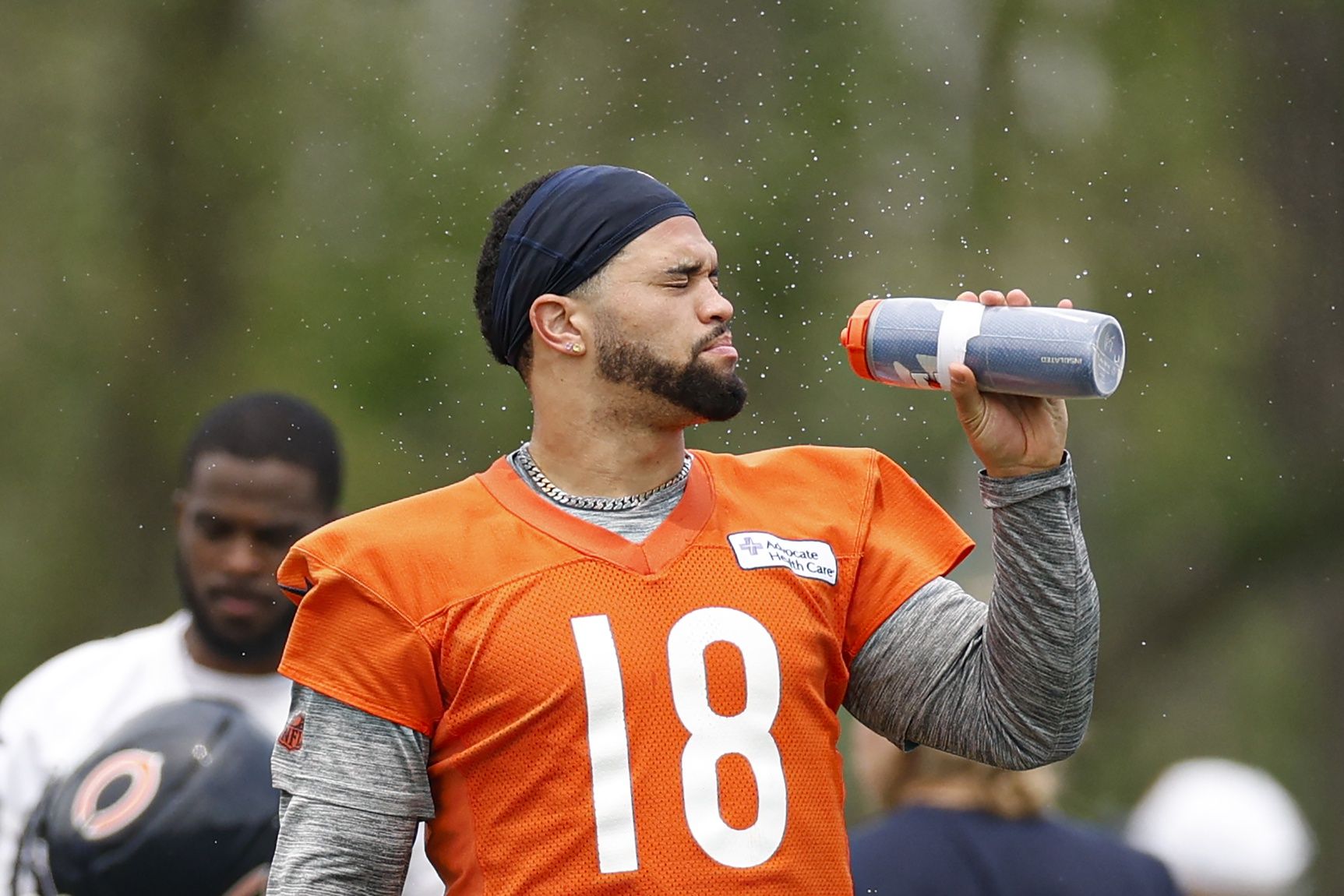 Chicago Bears quarterback Caleb Williams (18) cools off during minicamp at Halas Hall.