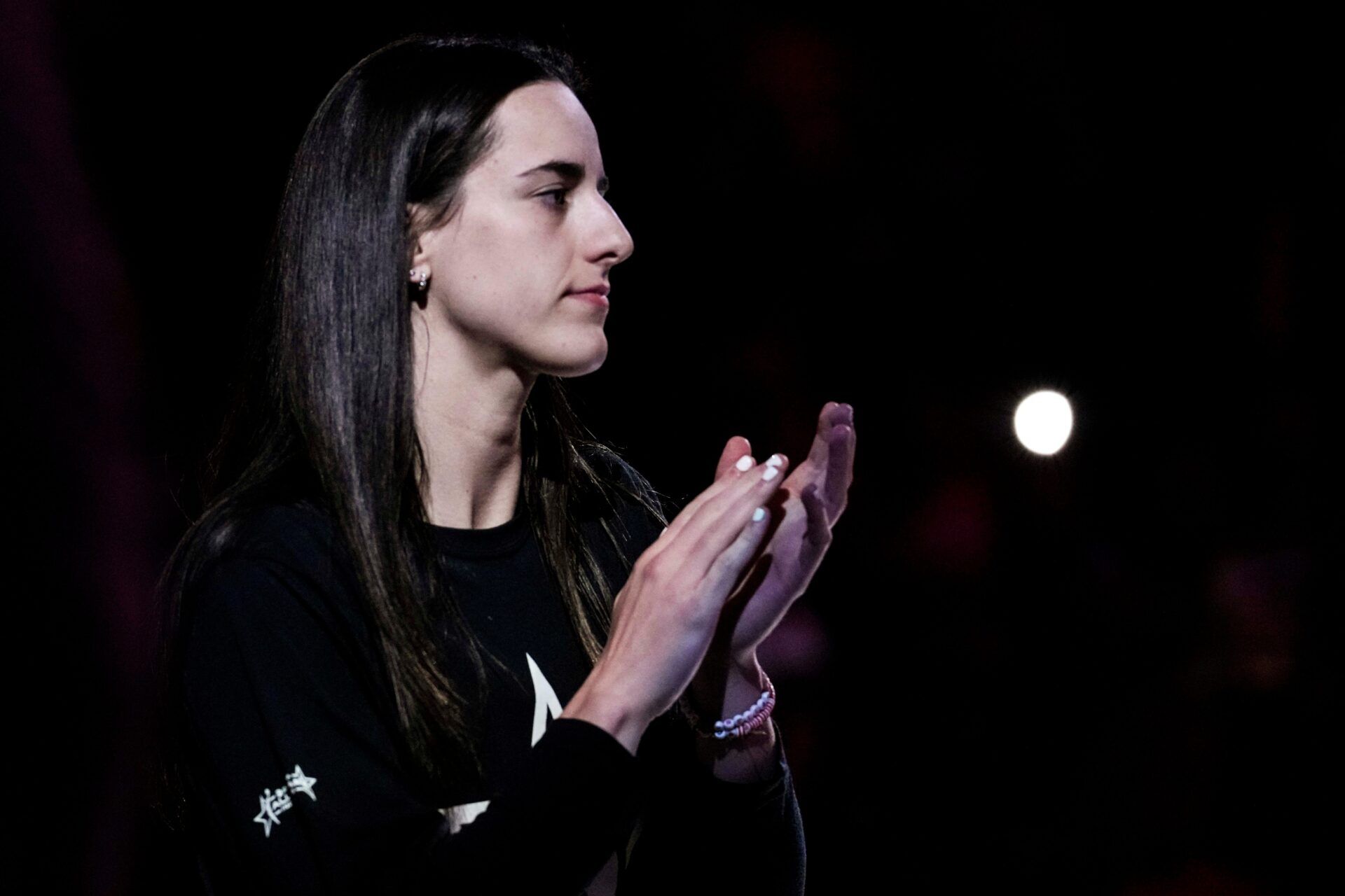 Indiana Fever guard Caitlin Clark (22) claps Thursday, July 3, 2025, during team introductions at a game between the Indiana Fever and the Las Vegas Aces at Gainbridge Fieldhouse in Indianapolis.