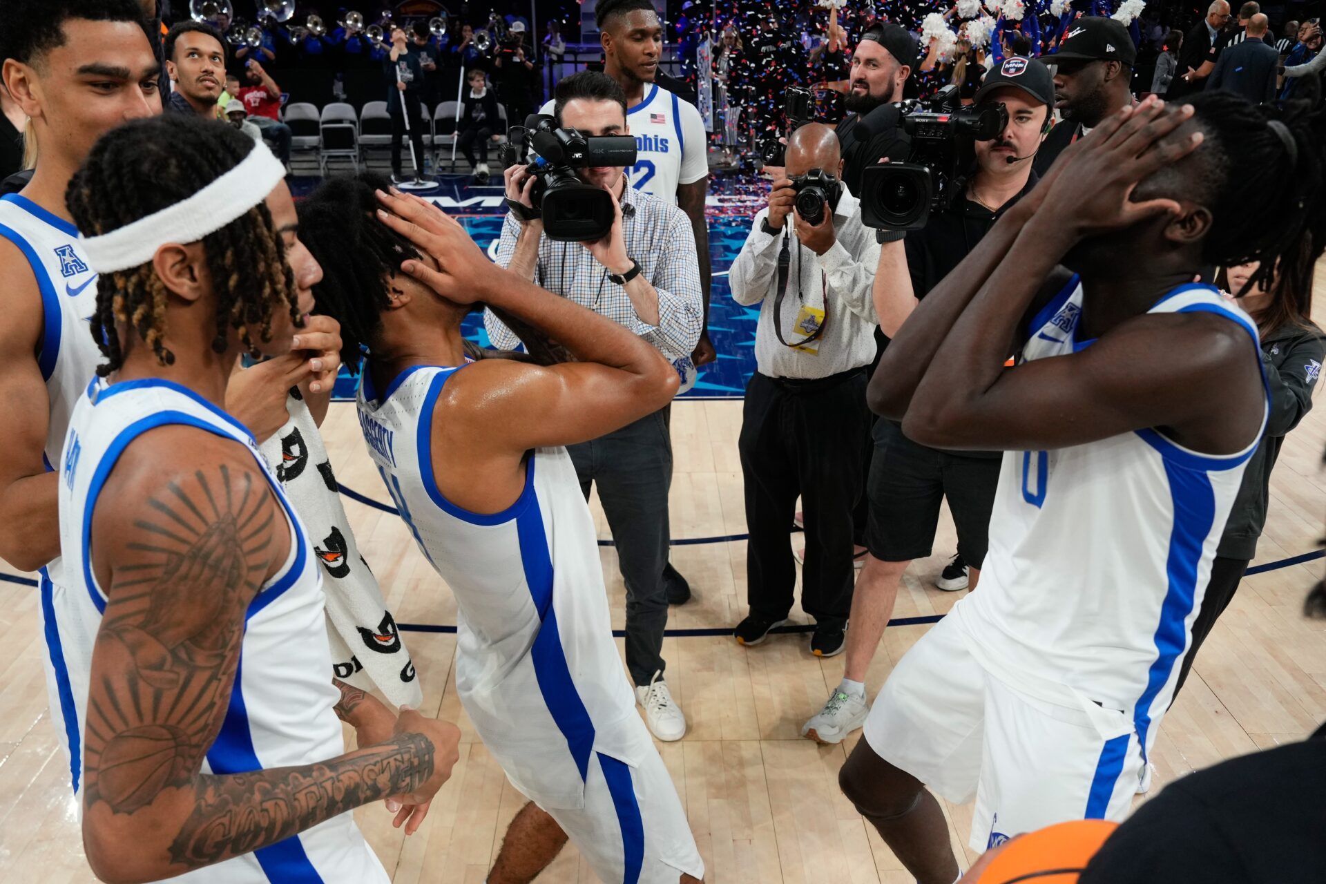 The Memphis Tigers basketball team reacts after defeating the UAB Blazers for the American Athletic Conference Championship atÊDickies Arena.