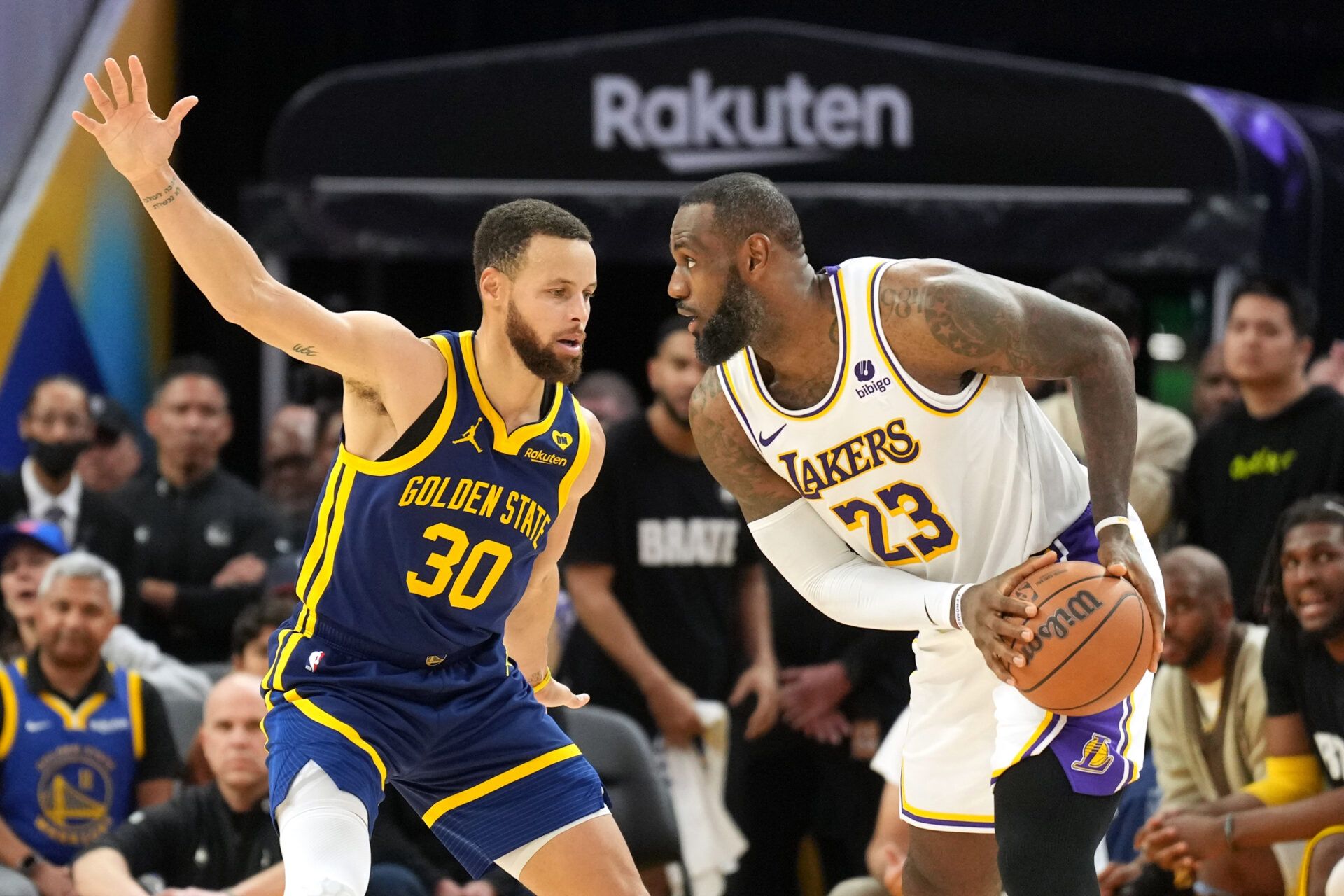 Los Angeles Lakers forward LeBron James (23) handles the ball against Golden State Warriors guard Stephen Curry (30) during overtime at Chase Center.