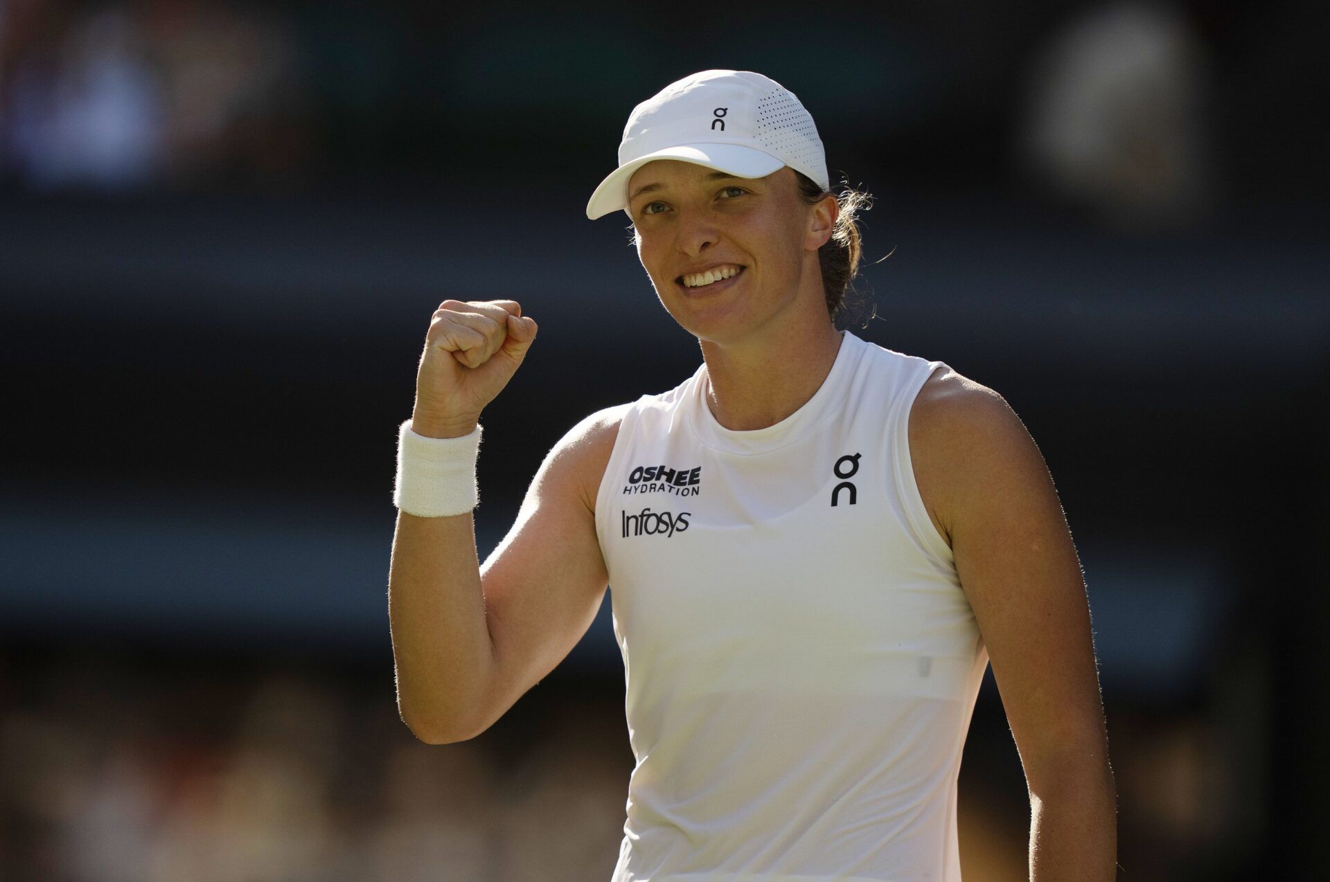Iga Swiatek of Poland celebrates winning her match against Belinda Bencic of Switzerland on day 11 at All England Lawn Tennis and Croquet Club.