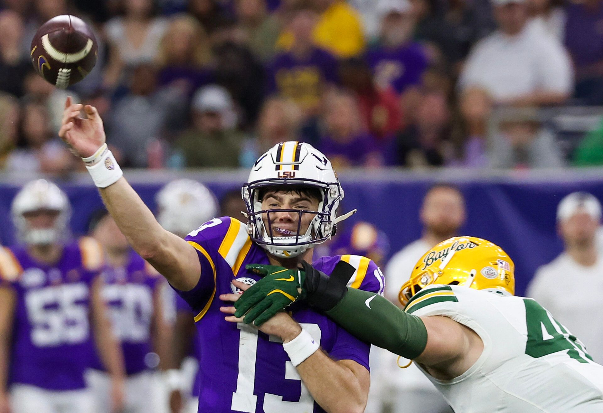 LSU Tigers quarterback Garrett Nussmeier (13) is hit by Baylor Bears linebacker Josh White (44) in the second half at NRG Stadium.