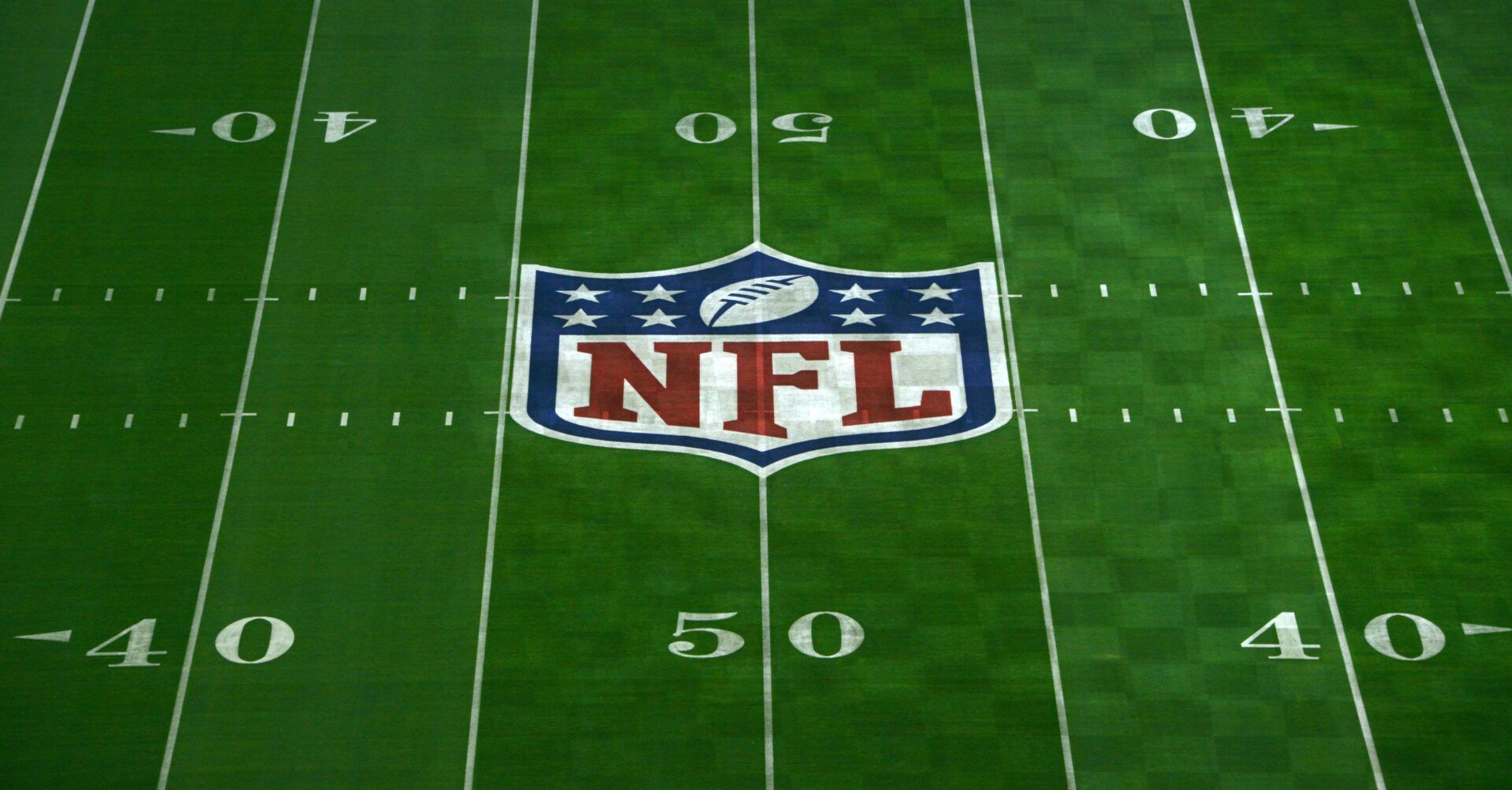 General view of NFL shield logo at midfield of University of Phoenix Stadium in advance of Super Bowl XLIX between the Seattle Seahawks and the New England Patriots.
