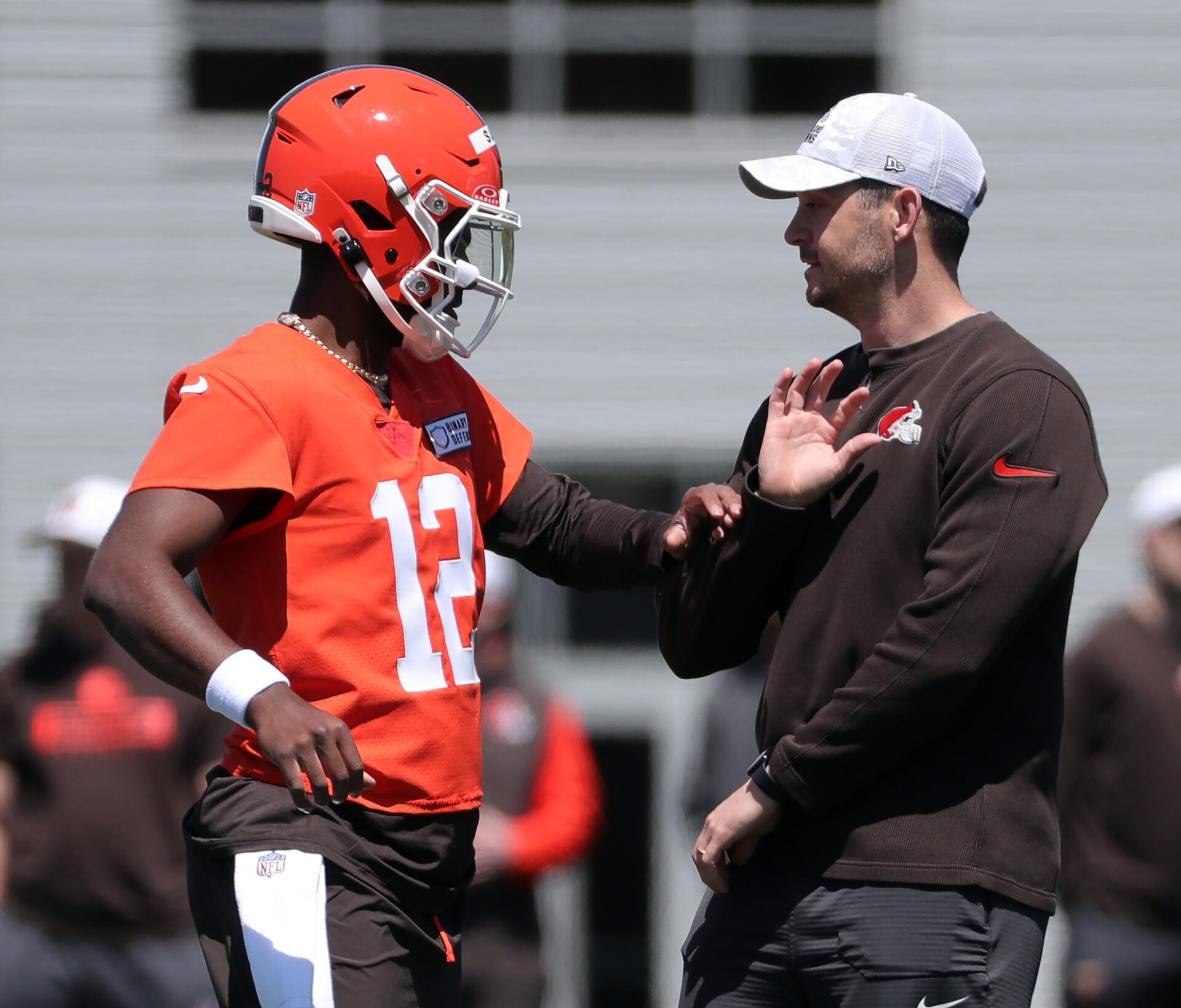 Cleveland Browns quarterback Shedeur Sanders (12) works with offensive coordinator Tommy Rees during rookie minicamp May 9, 2025, in Berea, Ohio.