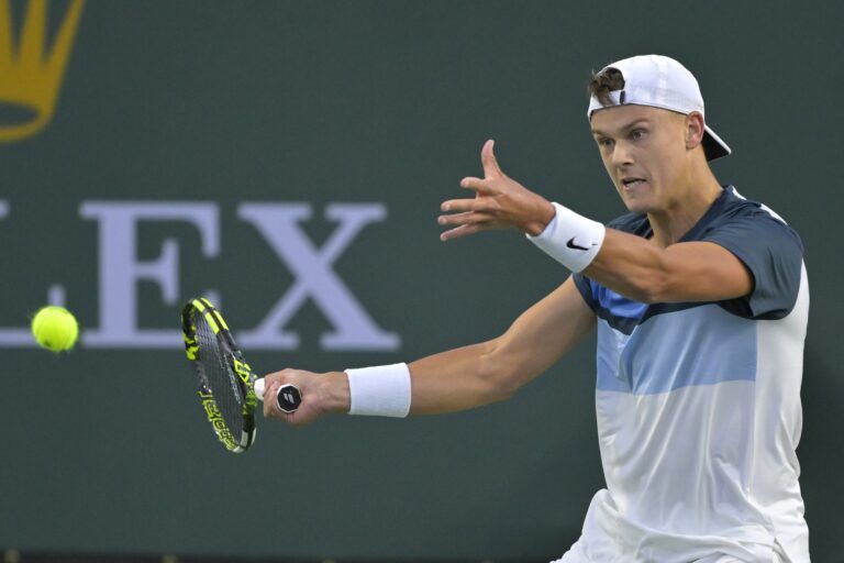 Holger Rune (DEN) hits a shot as he defeated Corentin Moutet (not pictured) in his second round match during the BNP Paribas Open at the Indian Well Tennis Garden.