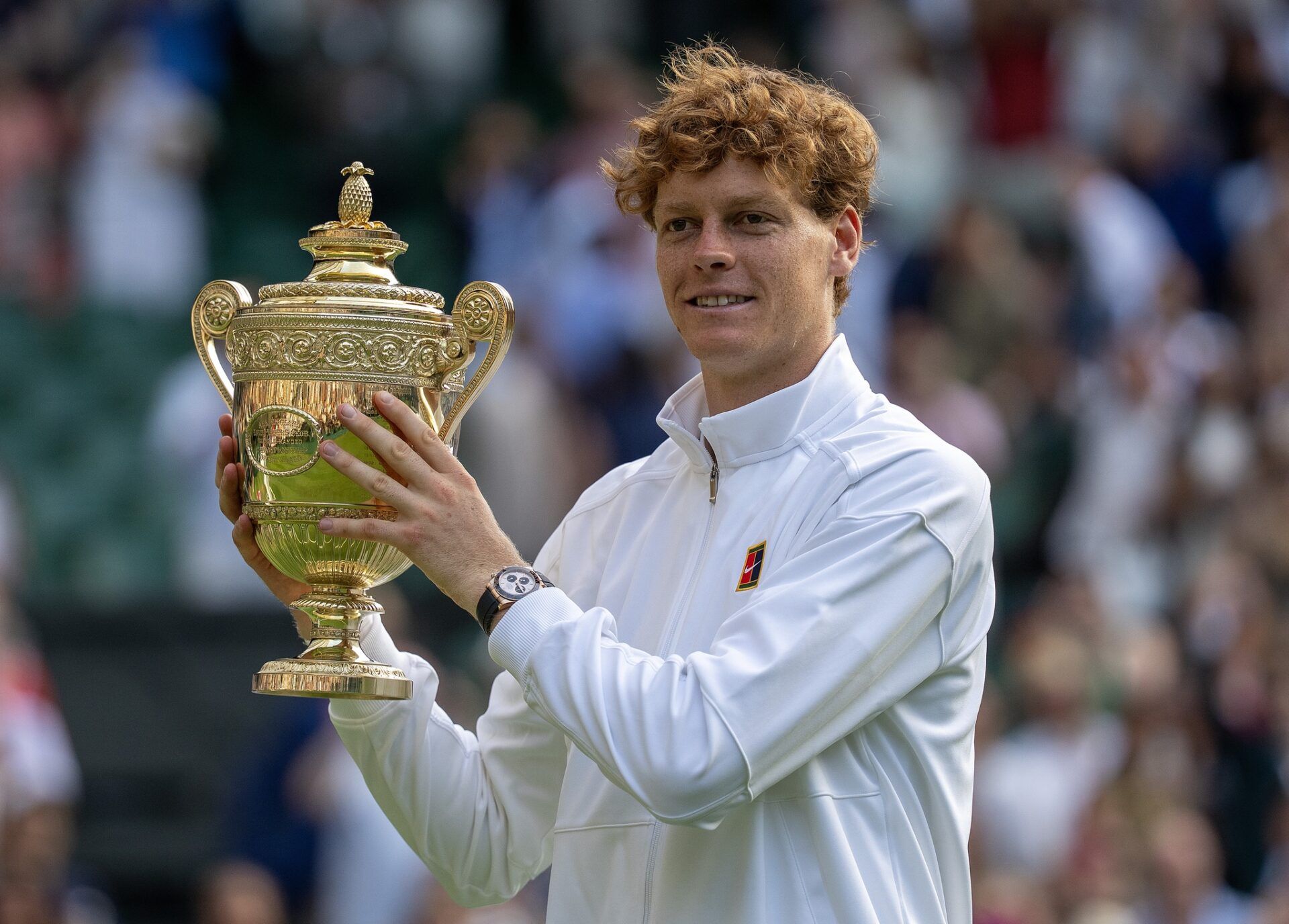 Jannik Sinner of Italy poses with the trophy after winning the menÕs singles final match against Carlos Alcaraz of Spain on day 14 at All England Lawn Tennis and Croquet Club.
