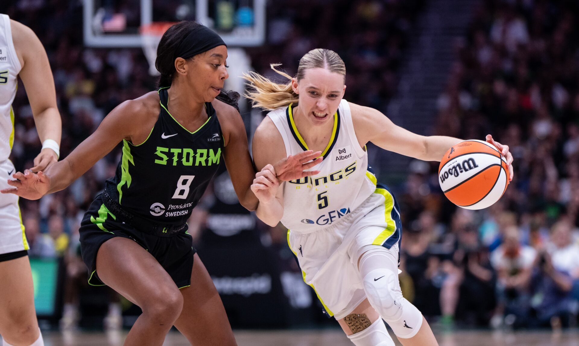 Dallas Wings guard Paige Bueckers (5) dribbles the ball against Seattle Storm guard Lexie Brown (8) during the second half at Climate Pledge Arena.