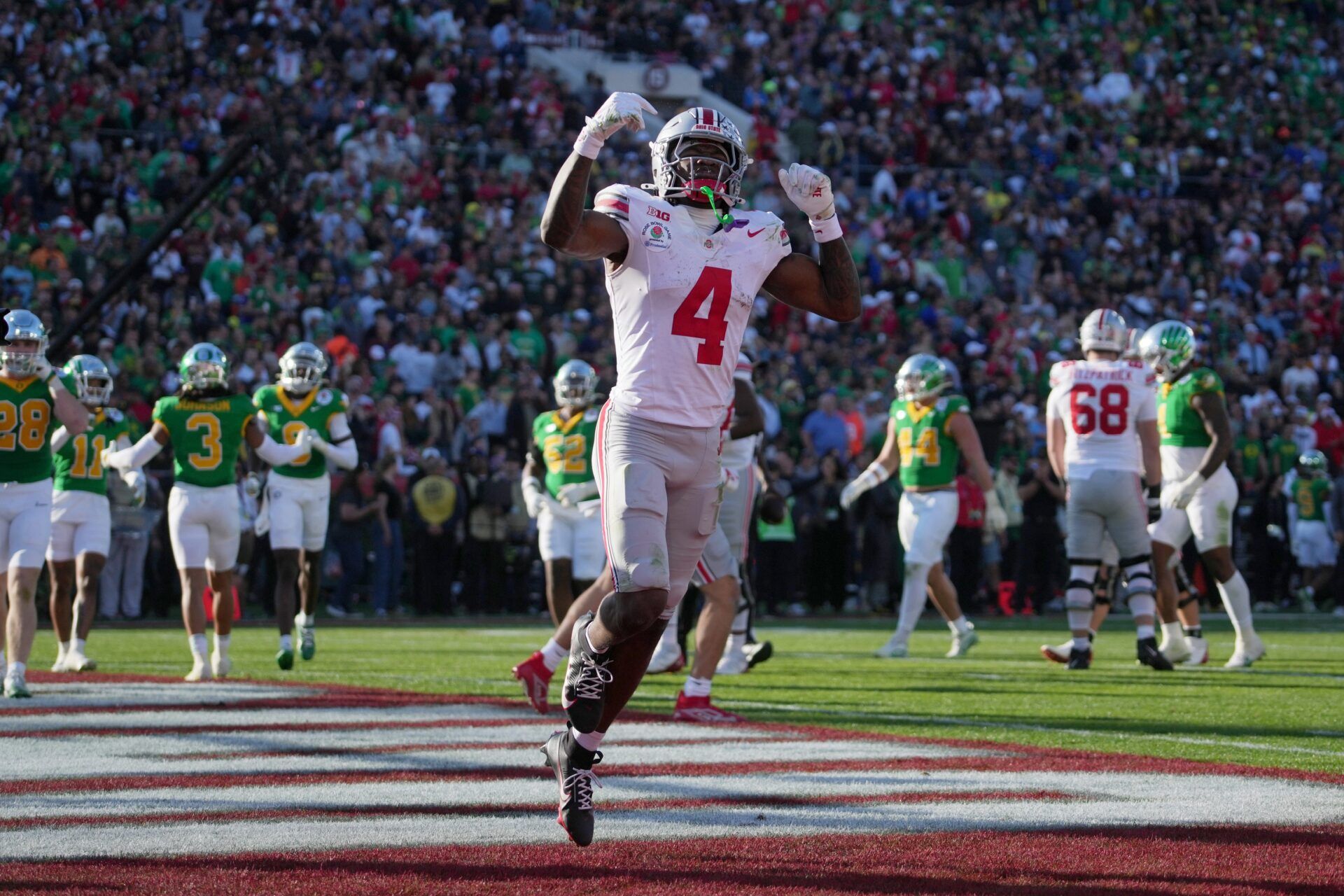 Ohio State Buckeyes wide receiver Jeremiah Smith (4) celebrates after scoring a touchdown against the Oregon Ducks in the second quarter in the 2025 Rose Bowl college football quarterfinal game at Rose Bowl Stadium.