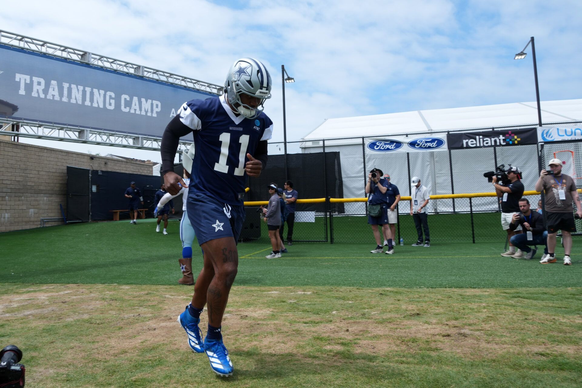 Dallas Cowboys defensive end Micah Parsons (11) enters the field during training camp at the River Ridge Fields.