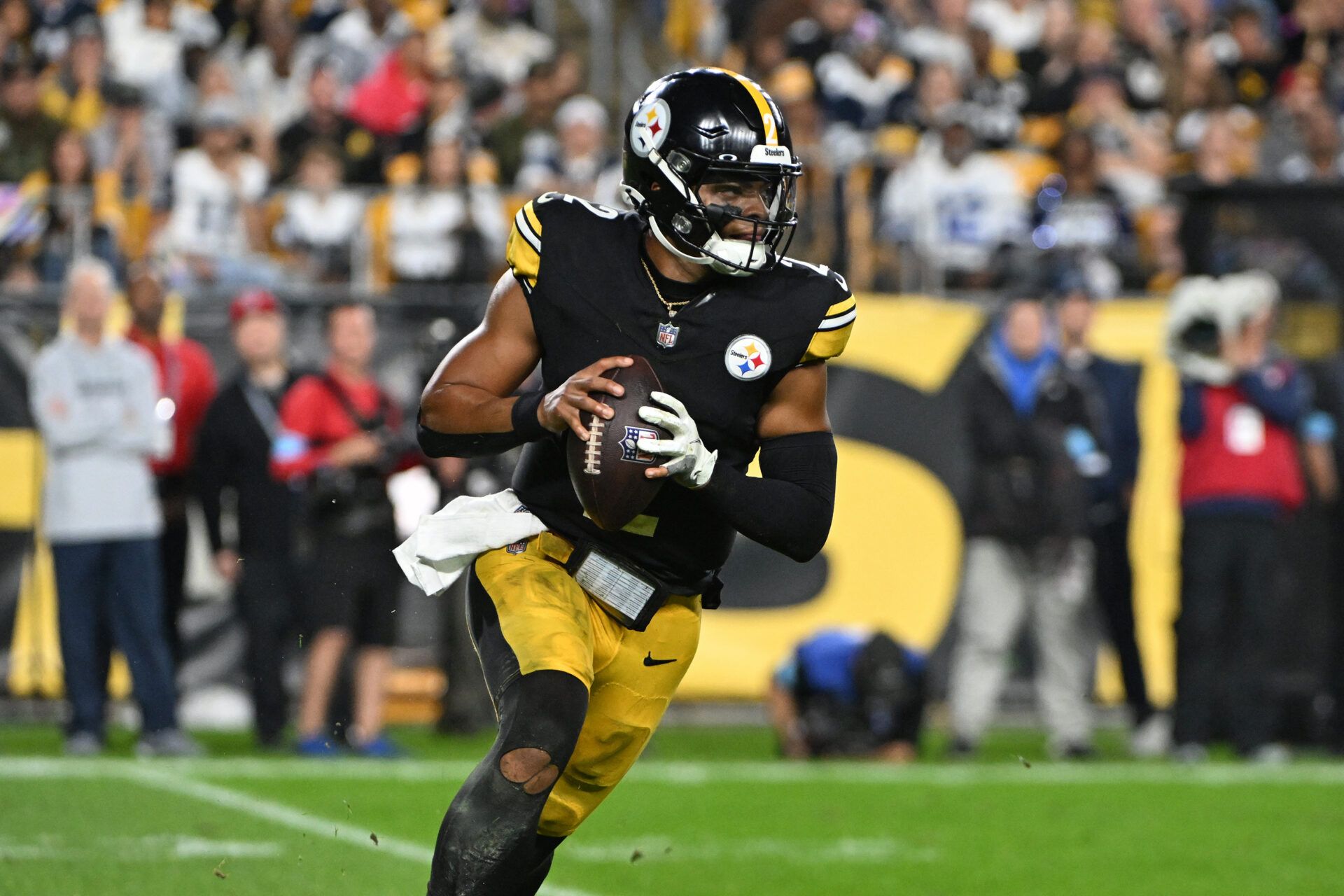 Pittsburgh Steelers quarterback Justin Fields (2) scrambles against the Dallas Cowboys during the first quarter at Acrisure Stadium.